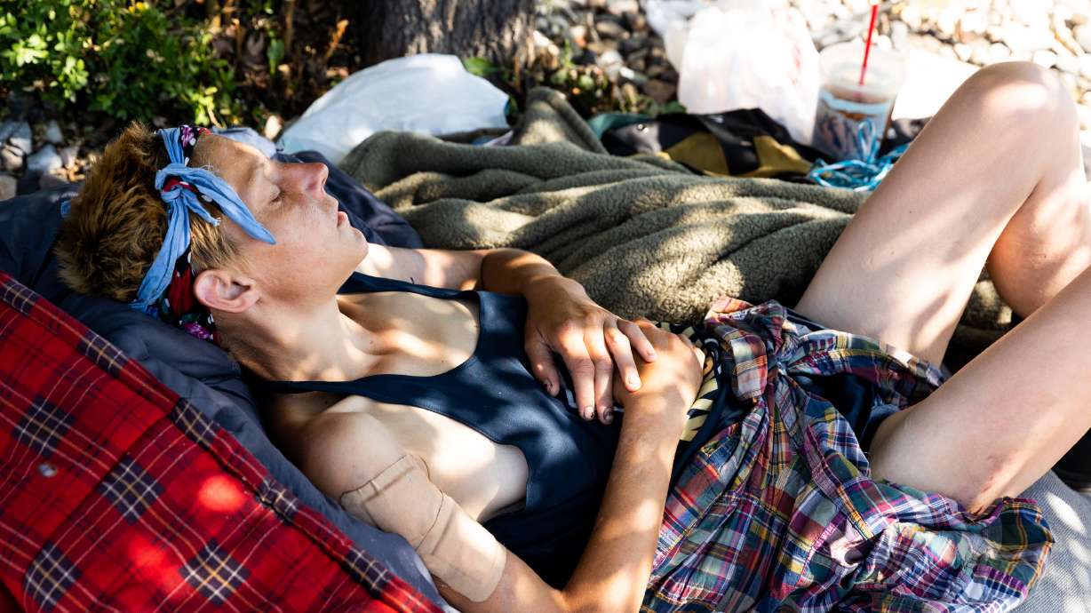 A person experiencing homelessness escapes the sun on State Street in Salt Lake City on July 21, 2023. The Salt Lake City Council voted Tuesday to allow several homeless resource centers to continue to expand capacity beyond the base level until the end of October.