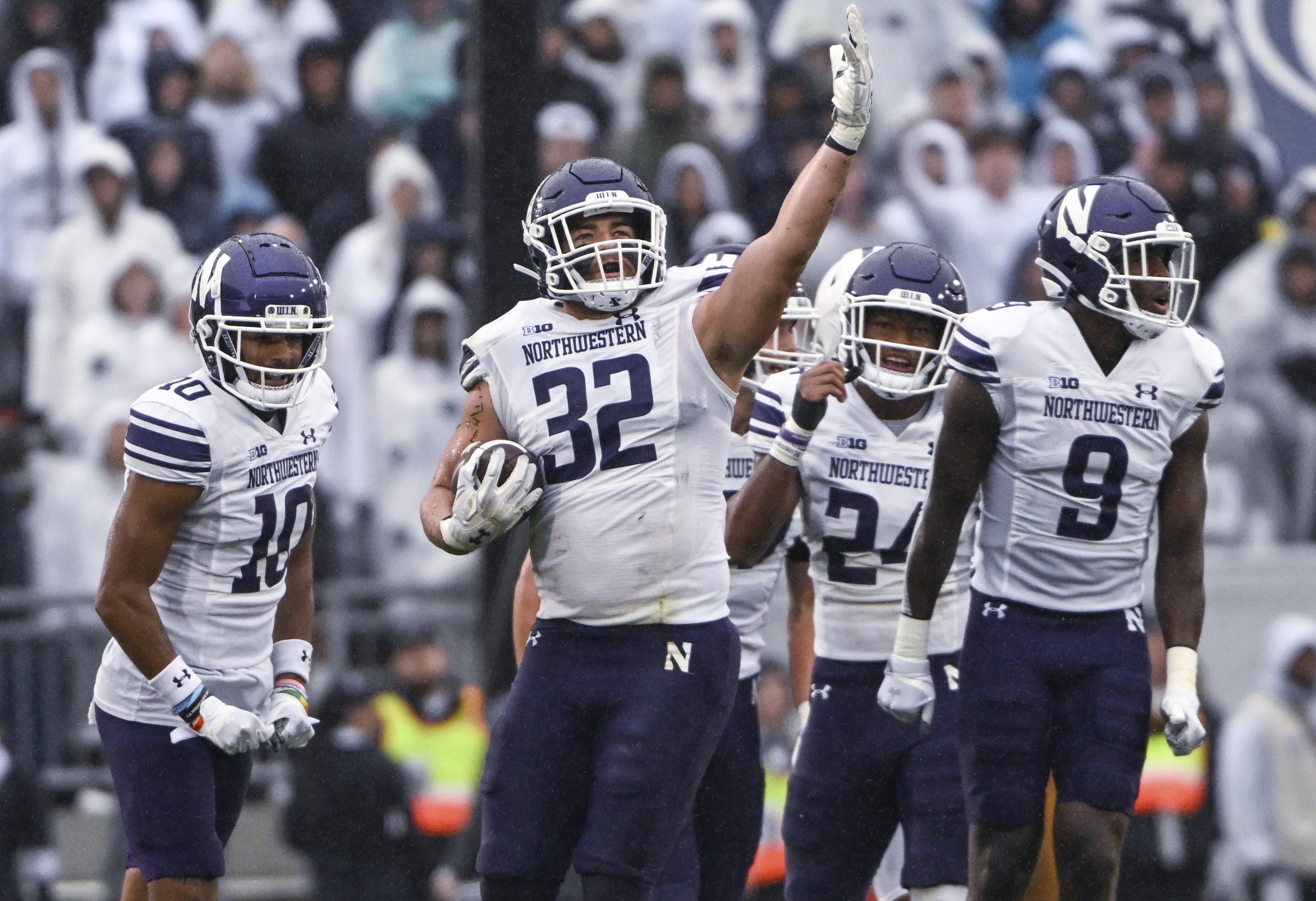 FILE - Northwestern linebacker Bryce Gallagher (32) celebrates after intercepting a Penn State pass during an NCAA college football game Oct. 1, 2022, in State College, Pa. Northwestern will not have any players at the Big Ten’s annual media days this week after the three who were scheduled to attend opted Tuesday, July 25, to back out because of hazing scandals that have engulfed the school. Gallagher, defensive back Rod Heard II and receiver Bryce Kirtz said in a statement they made the “very difficult” decision after consulting with interim coach David Braun, their parents and teammates.