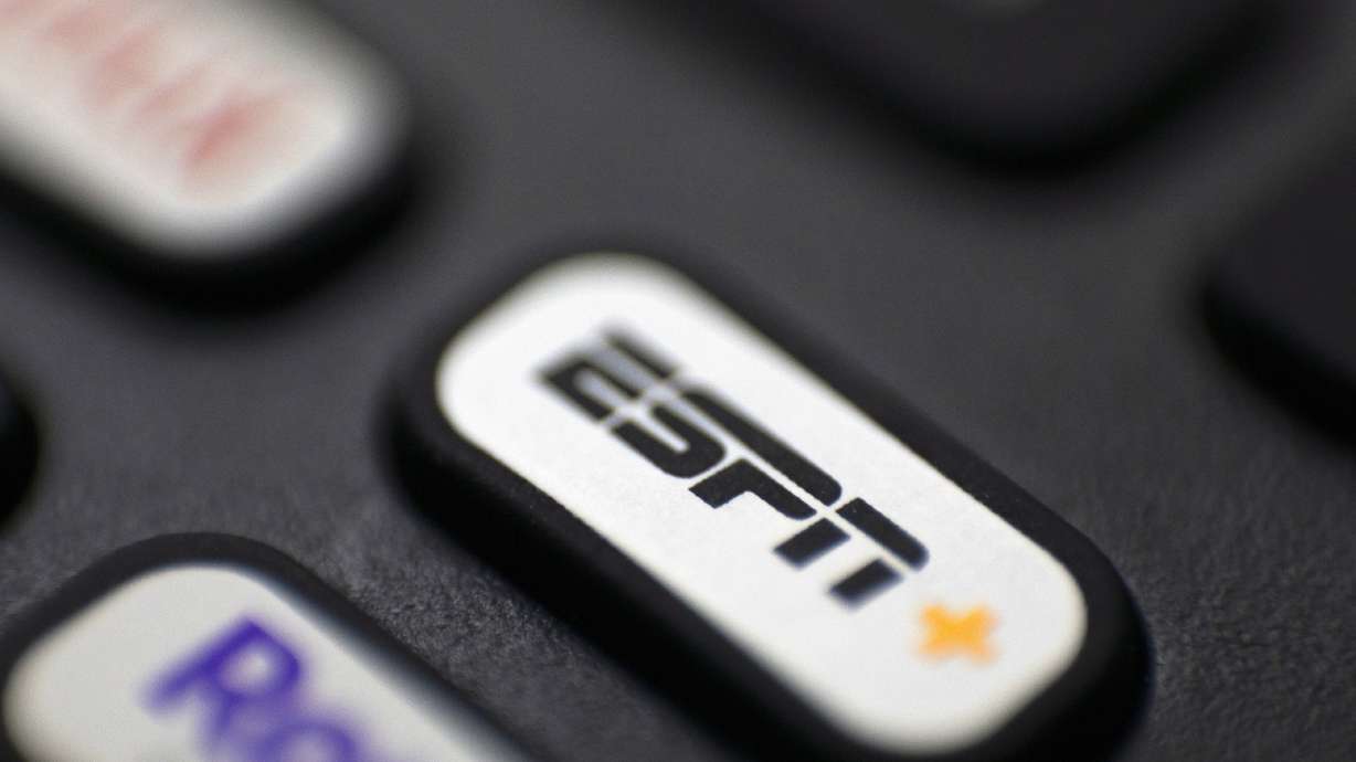 FILE - A button for ESPN+ is on a remote control in Portland, Ore., Aug. 13, 2022. ESPN chairman Jimmy Pitaro said Tuesday, July 25, 2023, it is possible the network could take on a sports league as a minority partner as the network continues to transition from a cable channel to a digital company.
