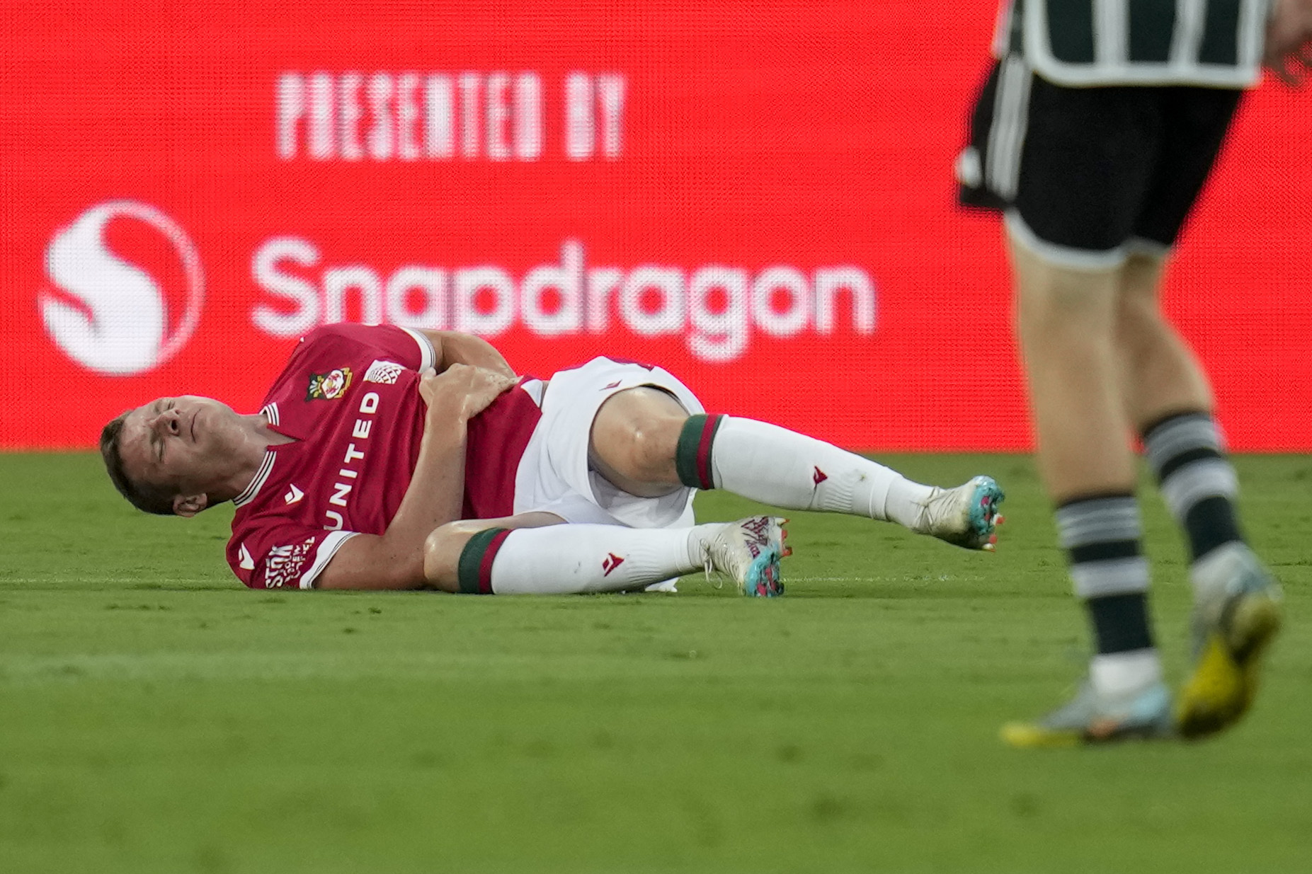 Wrexham forward Paul Mullin stays on the field after an injury during the first half of a club friendly soccer match against Manchester United, Tuesday, July 25, 2023, in San Diego. 
