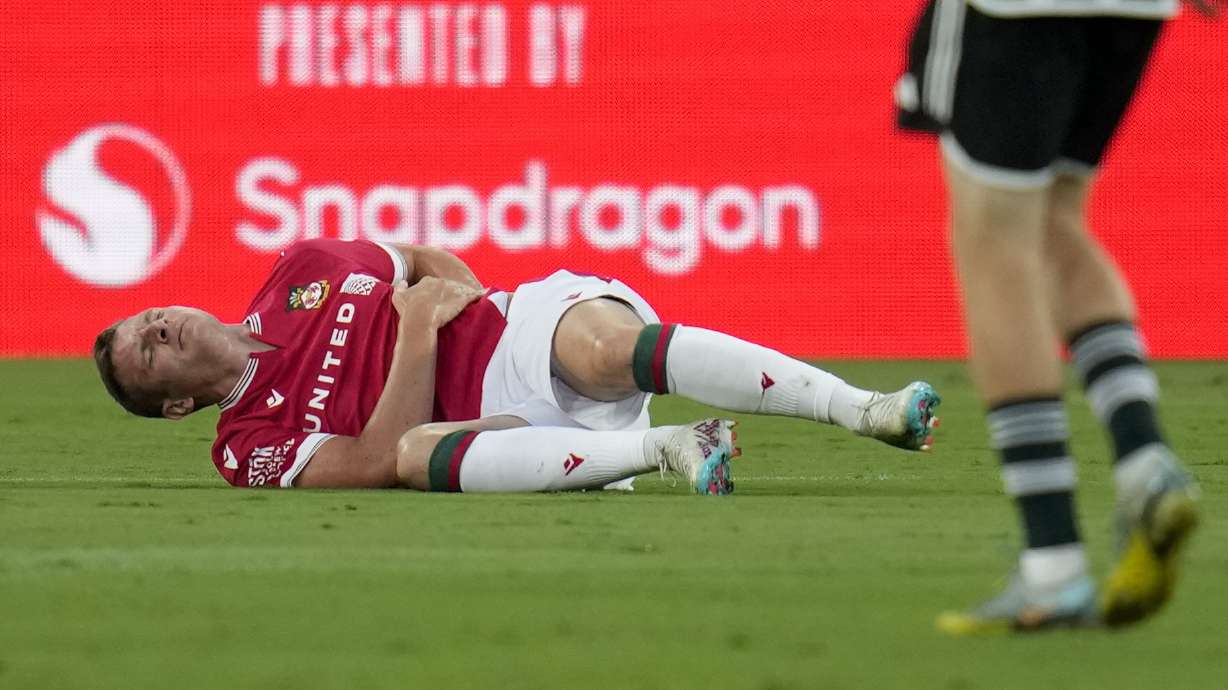 Wrexham forward Paul Mullin stays on the field after an injury during the first half of a club friendly soccer match against Manchester United, Tuesday, July 25, 2023, in San Diego.