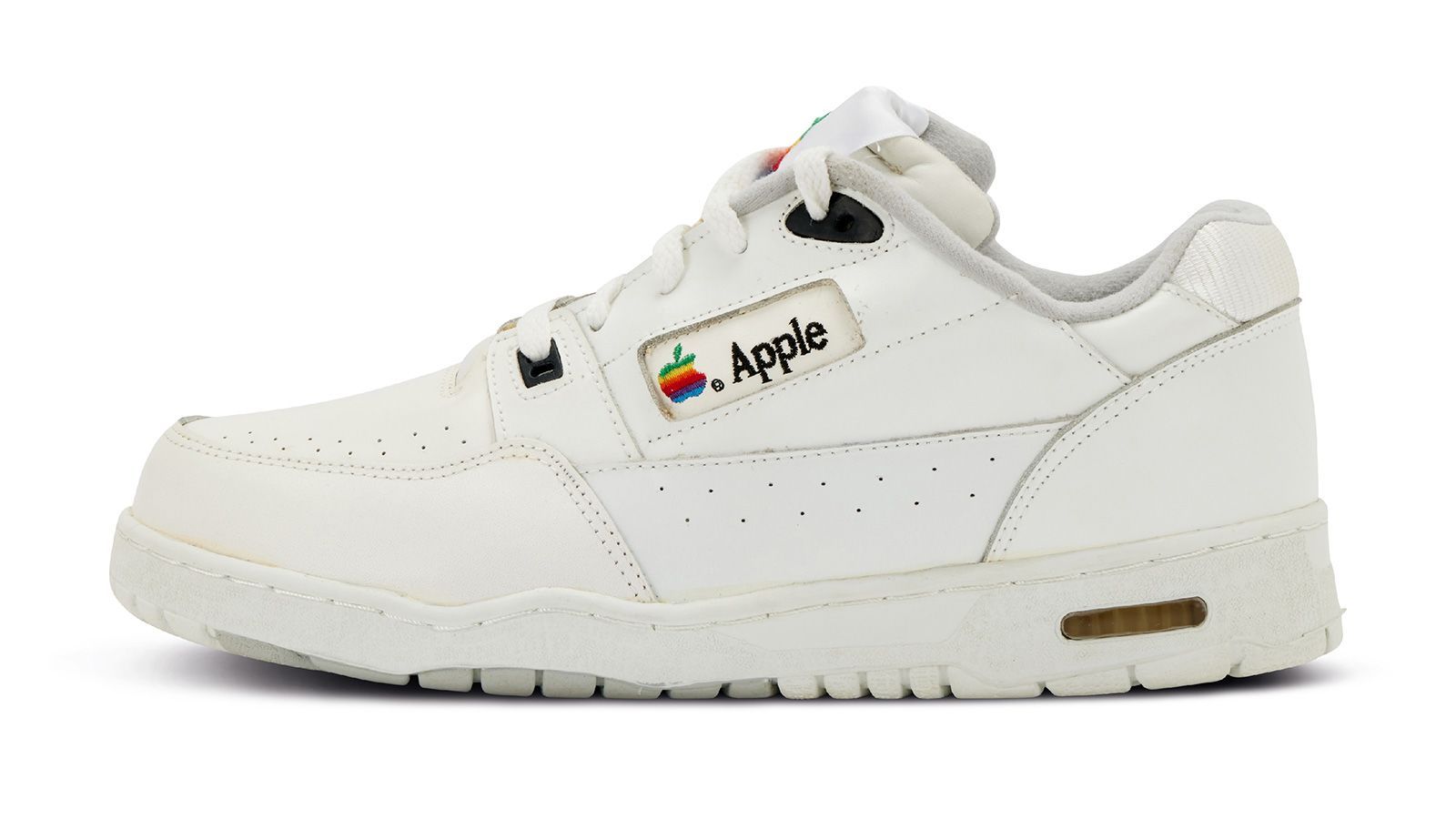 A pair of "ultra-rare" Apple sneakers is being sold by auctioneers for $50,000. The shoes come with red laces in the box.