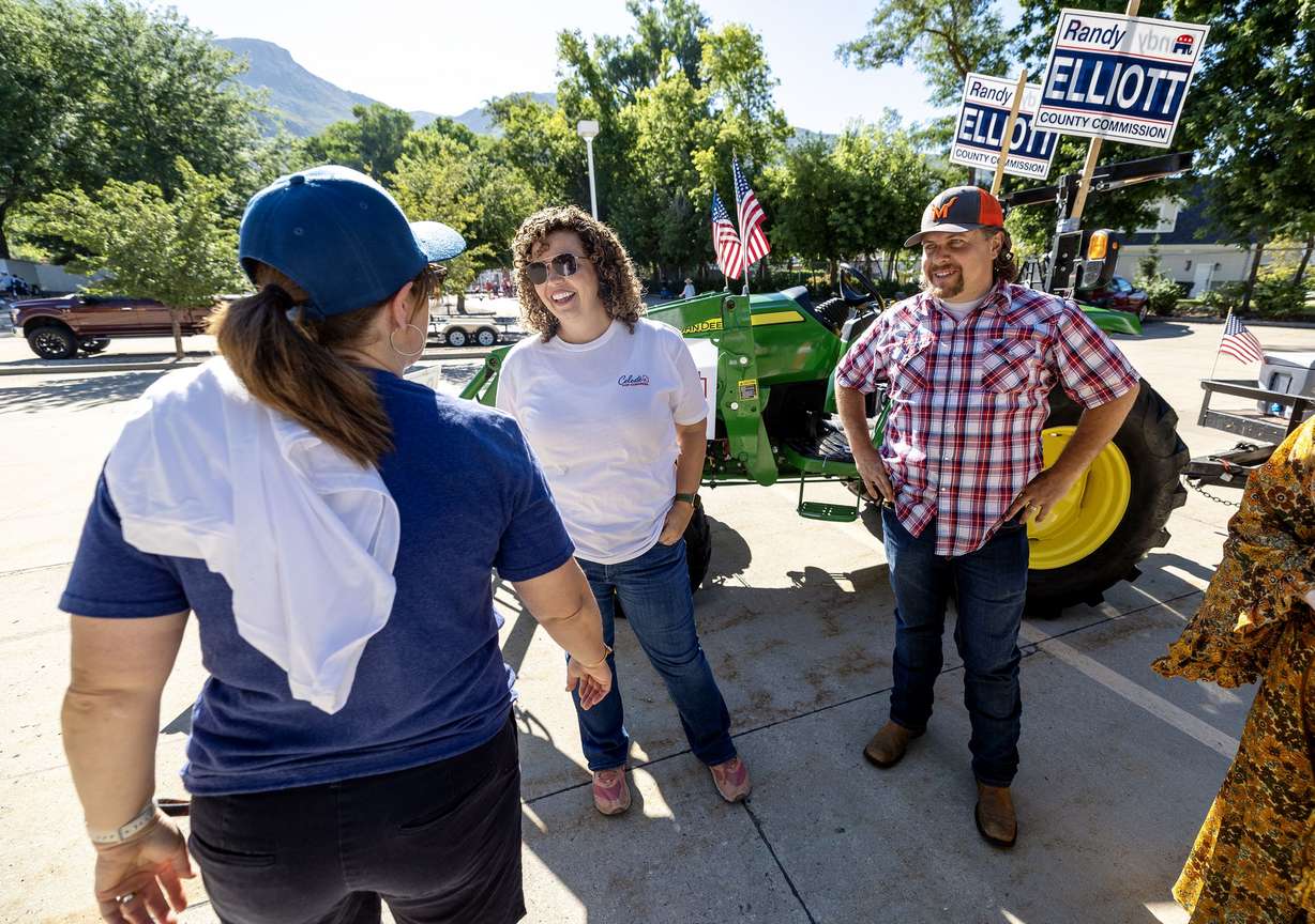 Celeste Maloy, congressional candidate, and Davis County Commissioner Randy Elliott talk with Maloy’s campaign manager, Rhonda Perkes, prior to participating in a parade in Farmington on July 15.