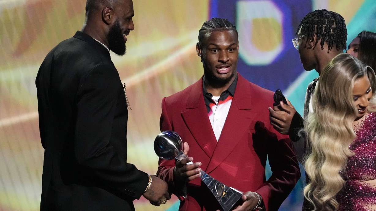 Los Angeles Lakers' LeBron James, left, accepts the award for best record-breaking performance from his sons, Bronny James, center, and Bryce James, at the ESPY awards July 12, 2023, in Los Angeles. Bronny James was hospitalized in stable condition Tuesday, July 25, 2023, a day after going into cardiac arrest while participating in a practice at the University of Southern California, a family spokesman said.