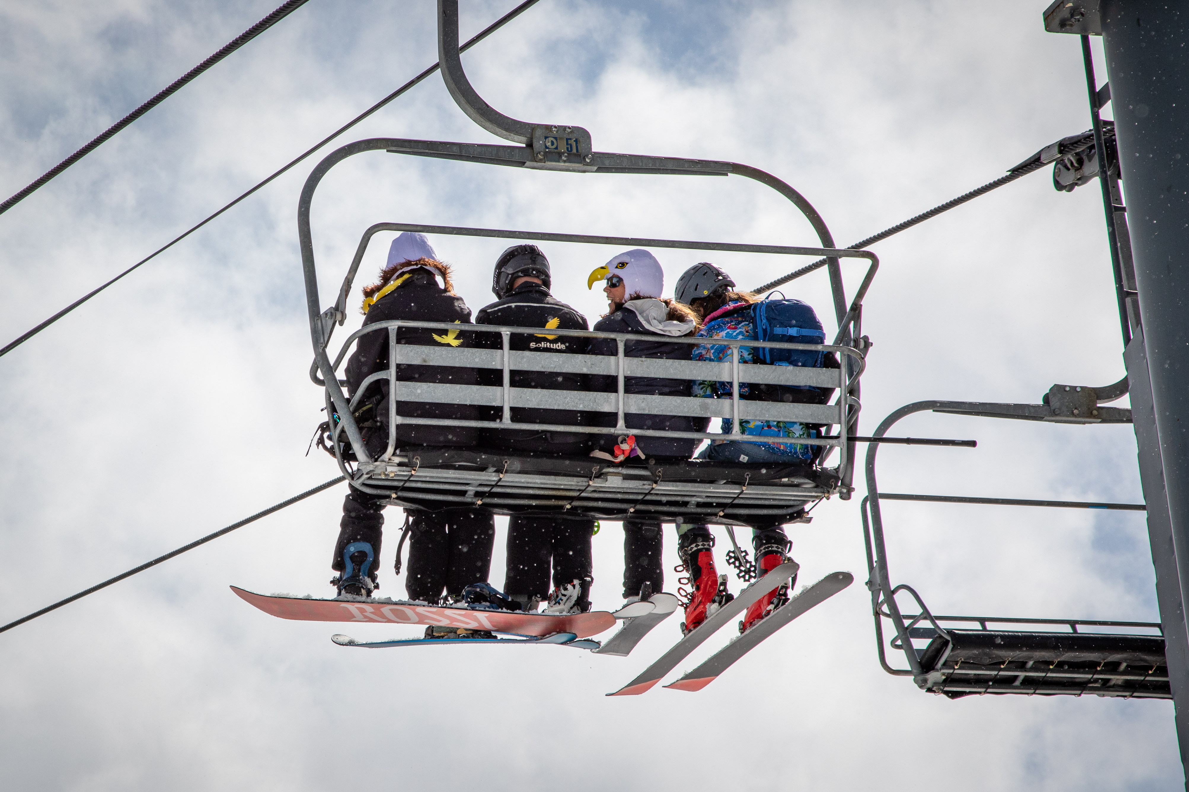 Skiers and snowboarders ride the Eagle Express lift at Solitude Mountain Resort. The lift chairs are headed for auction as it is replaced by a new high-speed, six-person lift.