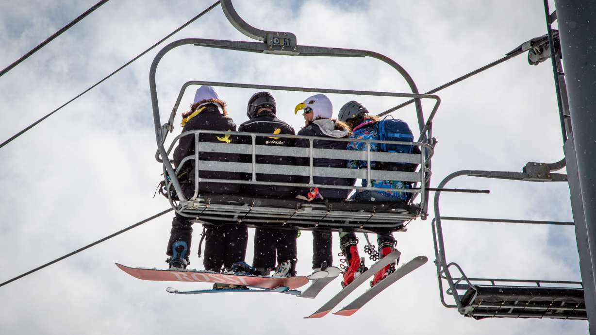 Skiers and snowboarders ride the Eagle Express lift at Solitude Mountain Resort. The lift chairs are headed for auction as it is replaced by a new high-speed, six-person lift.