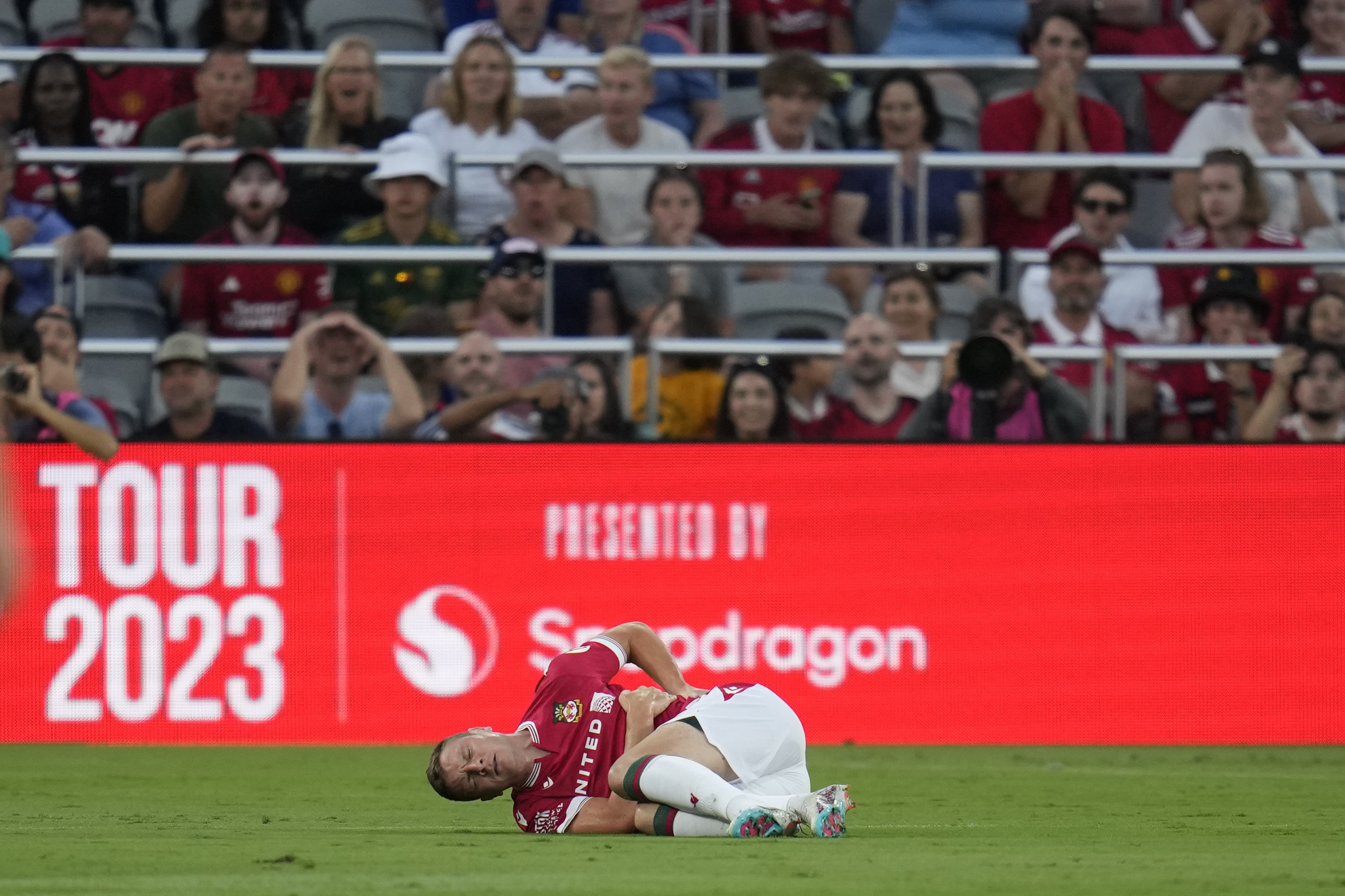Wrexham forward Paul Mullin stays on the field after an injury during the first half of a club friendly soccer match against Manchester United, Tuesday, July 25, 2023, in San Diego. 