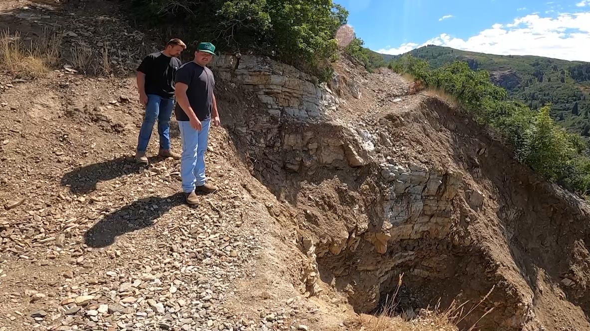 Tyson Zesiger and Luke Sowby stand above a washed-out area of the trail in Bountiful on Wednesday.