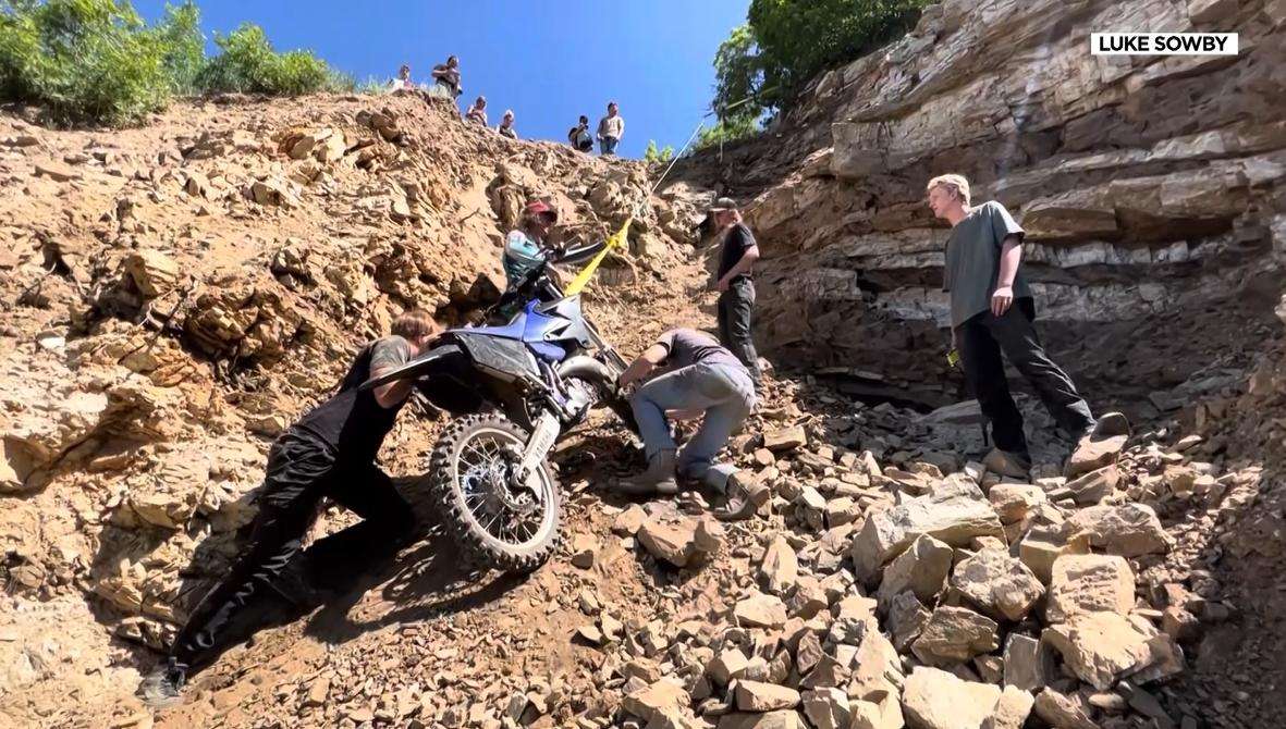 Volunteers recover a bike after rider Will Smith crashed over the edge and was severely injured in Bountiful.