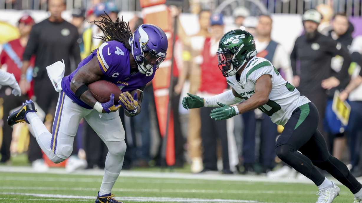 FILE - Minnesota Vikings running back Dalvin Cook (4) carries the ball against New York Jets cornerback Michael Carter II (30) during the second half of an NFL football game Sunday, Dec. 4, 2022 in Minneapolis. Free agent running back Dalvin Cook is scheduled to visit with the New York Jets this weekend, according to a person with knowledge of the situation.The former Minnesota Vikings star, who turns 28 in August, could join a revamped Jets offense led by quarterback Aaron Rodgers and coordinator Nathaniel Hackett.