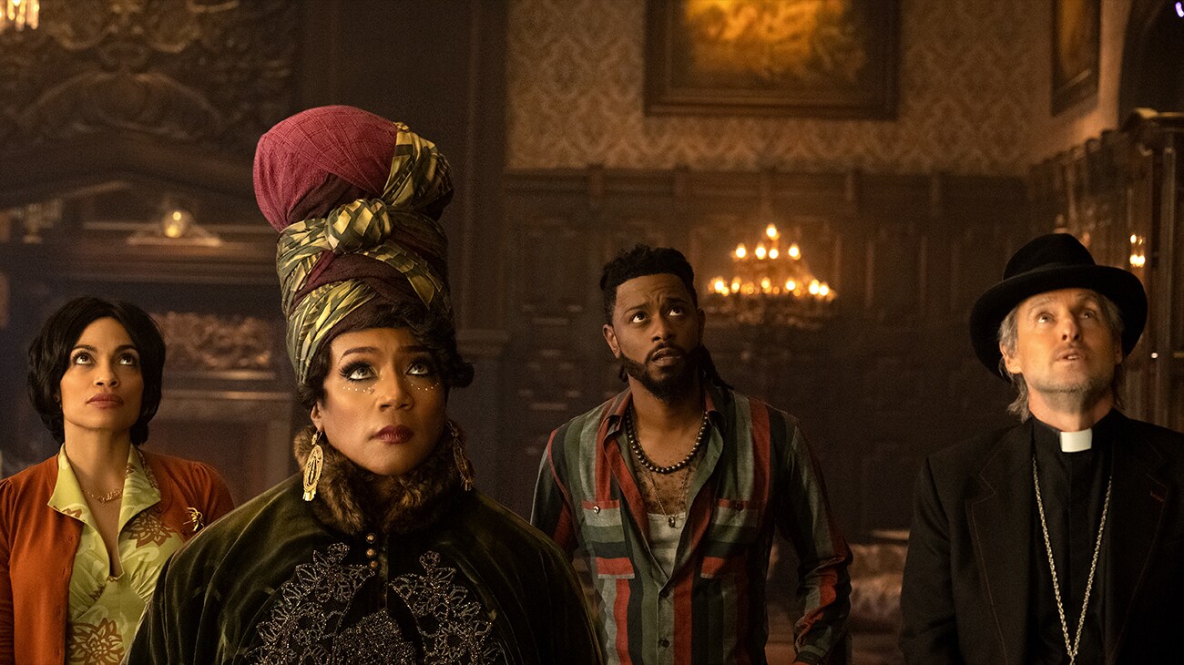 Rosario Dawson as Gabbie, Tiffany Haddish as Harriet, LaKeith Stanfield as Ben, and Owen Wilson as Father Kent in Disney's live-action "Haunted Mansion," which opens in theaters Friday.