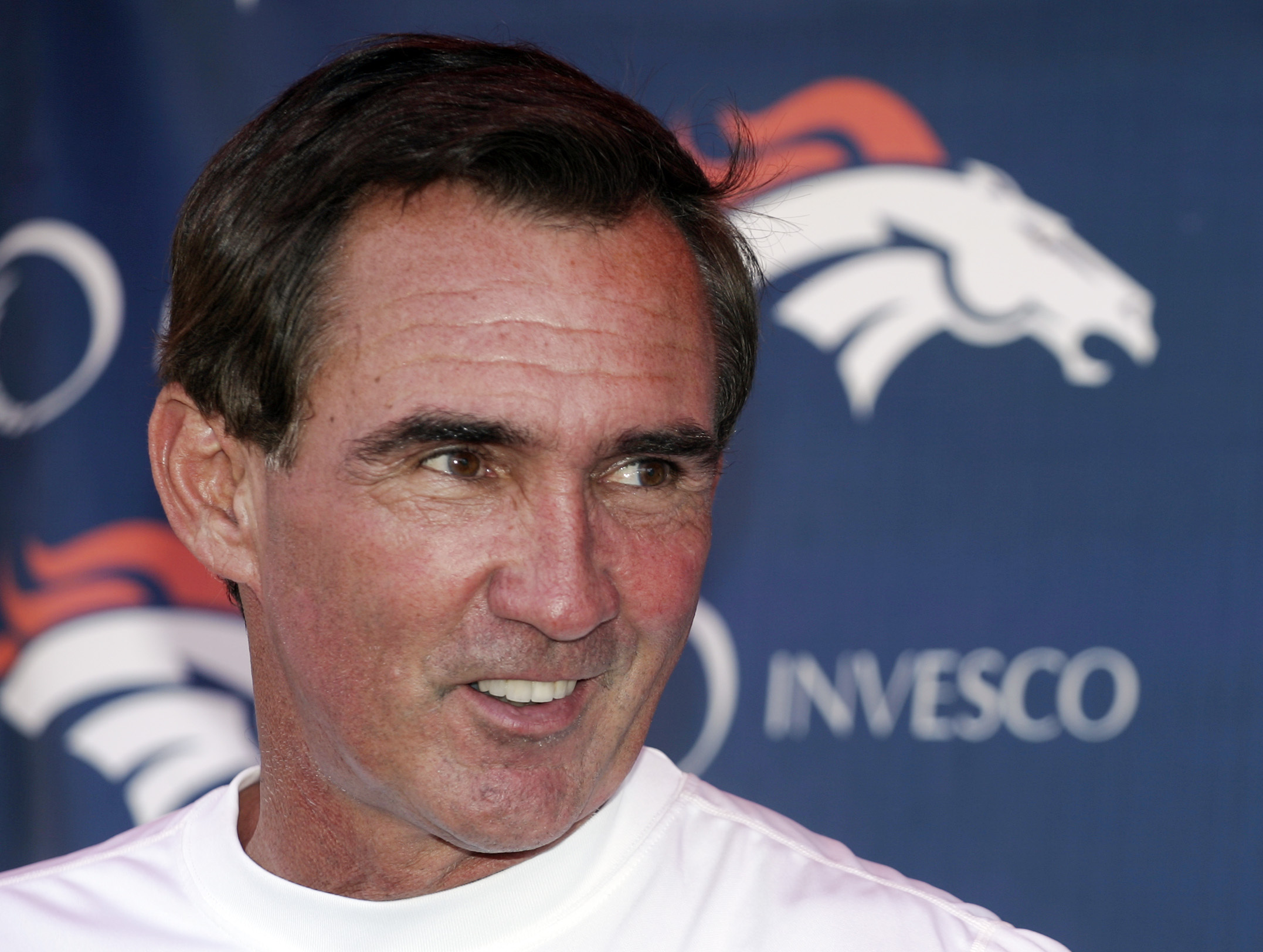 FILE - Denver Broncos head coach Mike Shanahan laughs as he talks to the media following the morning session of football training camp in Denver, Sunday, July 29, 2007. Versatile running back Roger Craig, and two-time Super Bowl-winning coaches Tom Coughlin and Mike Shanahan advanced to the next stage of consideration for the Pro Football Hall of Fame. The selection committees cut down the list of candidates from 31 seniors and 29 coaches and contributors to 12 in each category in results announced Thursday, July 27, 2023. 