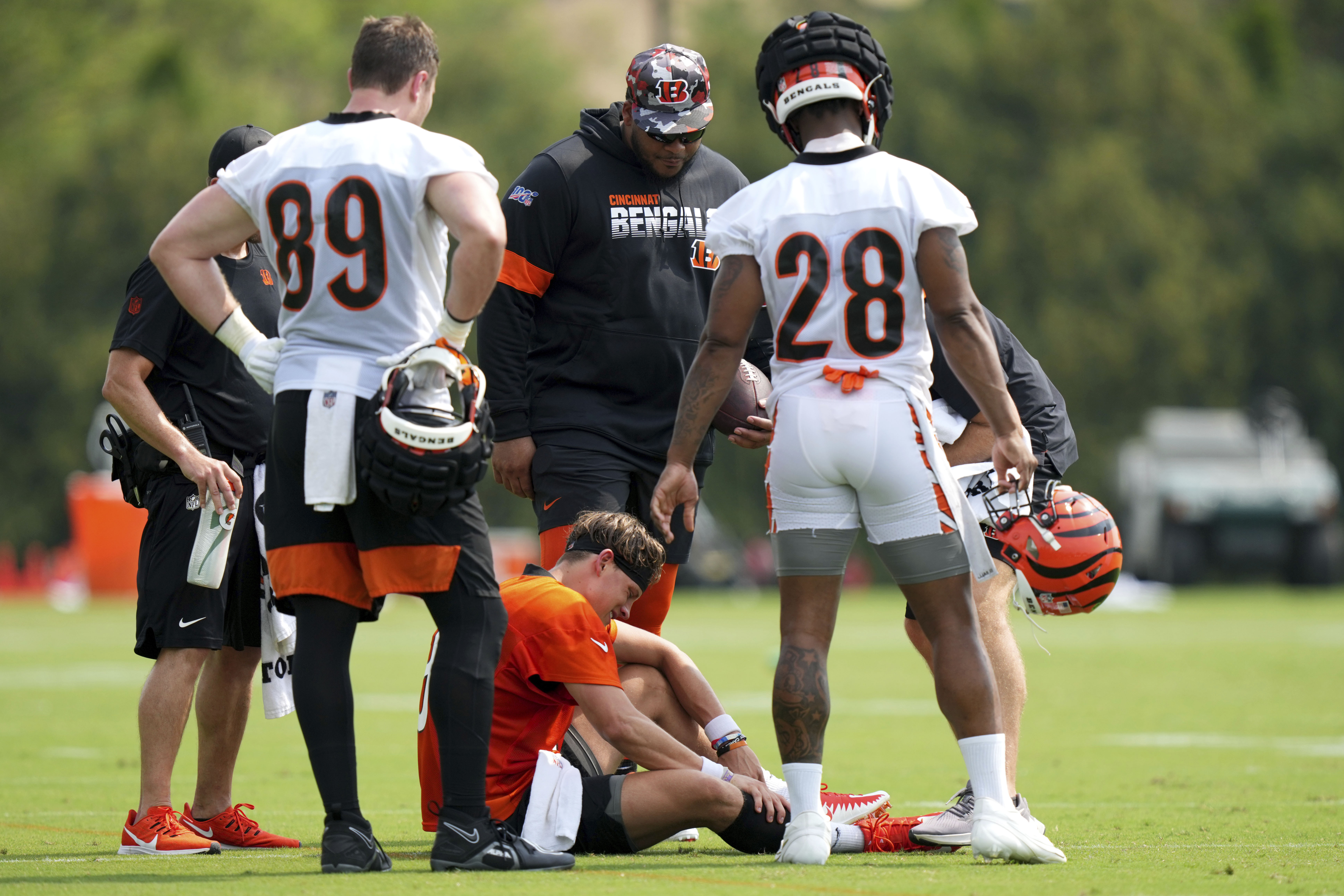 Cincinnati Bengals quarterback Joe Burrow (9) grabs his calf after an injury on a scramble play during NFL football training camp, Thursday, July 27, 2023, in Cincinnati.