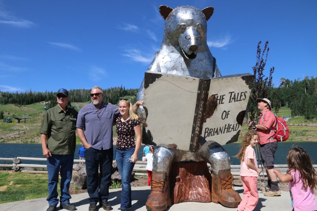 Sculptors pose in front of "Brian the Bear" sculpture, Brian Head, Utah, Monday. Brian Head’s newest residents, a quartet of metal bear sculptures, were officially welcomed to town on Monday