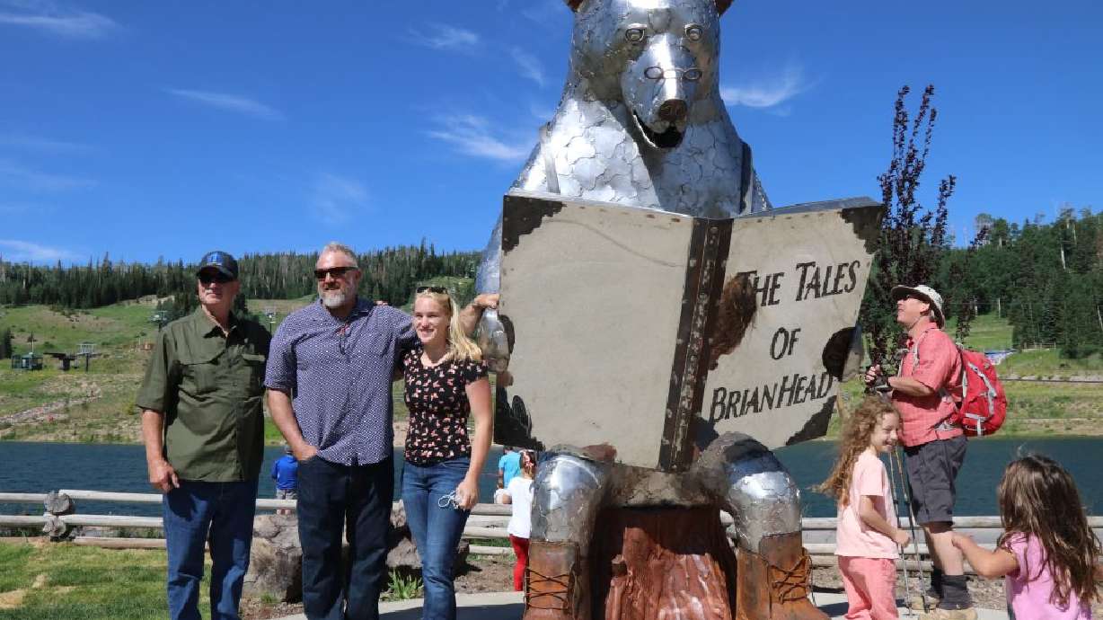 Sculptors pose in front of "Brian the Bear" sculpture, Brian Head, Utah, Monday. Brian Head’s newest residents, a quartet of metal bear sculptures, were officially welcomed to town on Monday