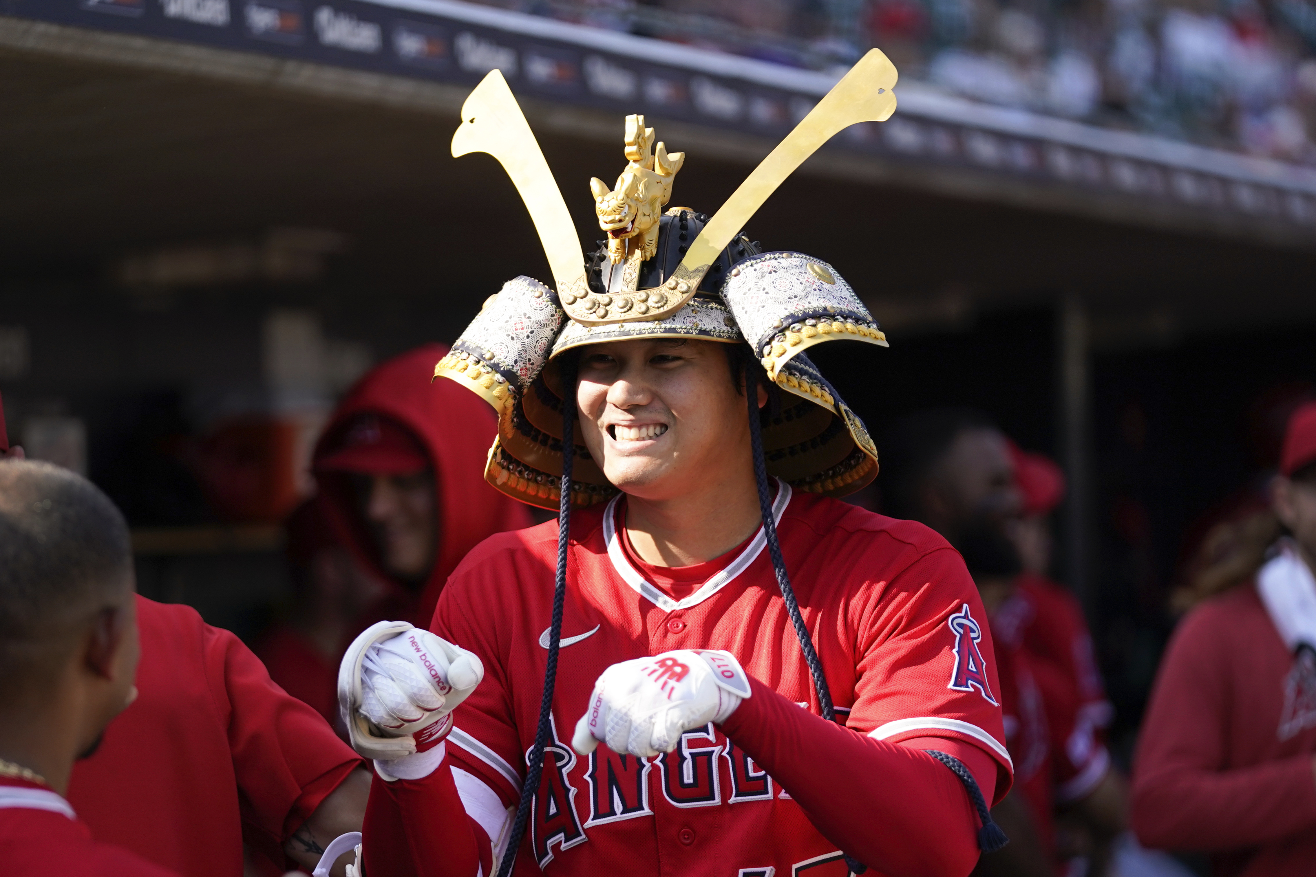 Los Angeles Angels' Shohei Ohtani celebrates wearing a Kabuto samurai warrior helmet after his home run against the Detroit Tigers in the fourth inning during the second baseball game of a doubleheader, Thursday, July 27, 2023, in Detroit. 