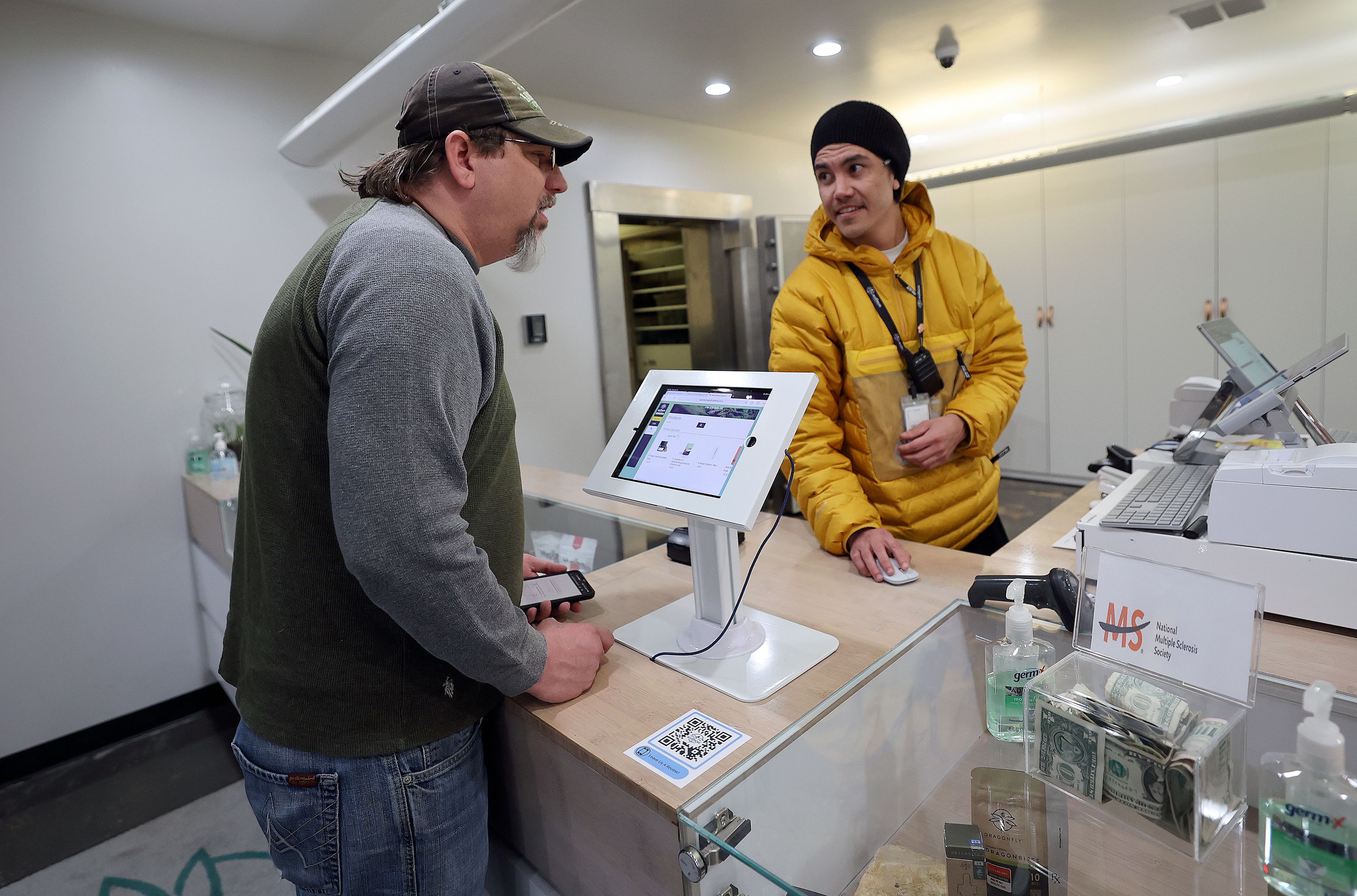 Robert Stosich talks with Dragonfly Wellness fulfillment manager Dio Bone about his options as he purchases medical cannabis for the first time at Dragonfly Wellness in Salt Lake City on April 20. Stosich hopes to use medical cannabis for anxiety and bipolar disorder.