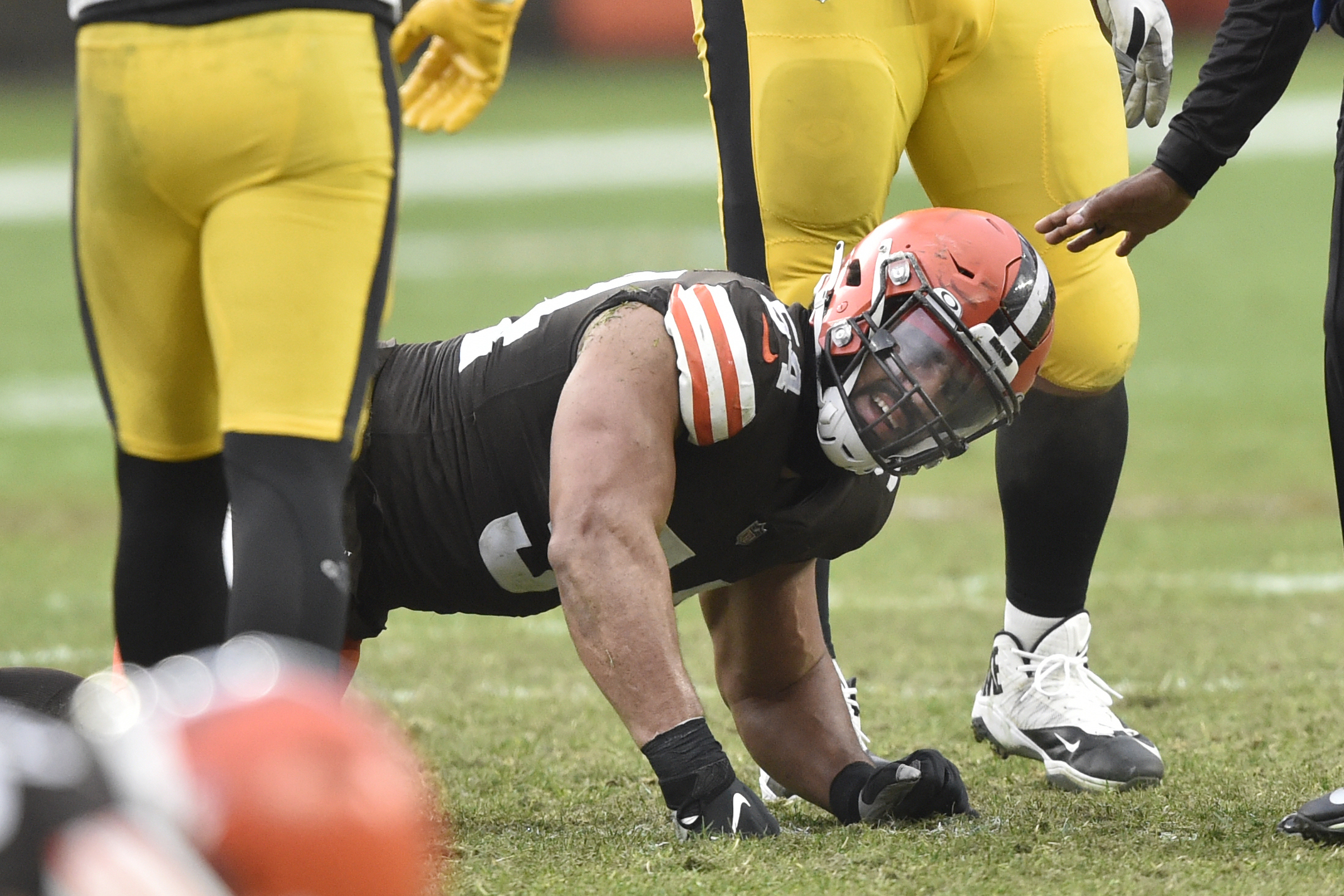 Cleveland Browns defensive end Olivier Vernon reacts after an injury in the fourth quarter of an NFL football game against the Pittsburgh Steelers, Sunday, Jan. 3, 2021, in Cleveland. Hamstring pulls, ligament tears and ankle sprains can be as formidable an opponent for NFL teams as a high-scoring offense or stingy defense. 