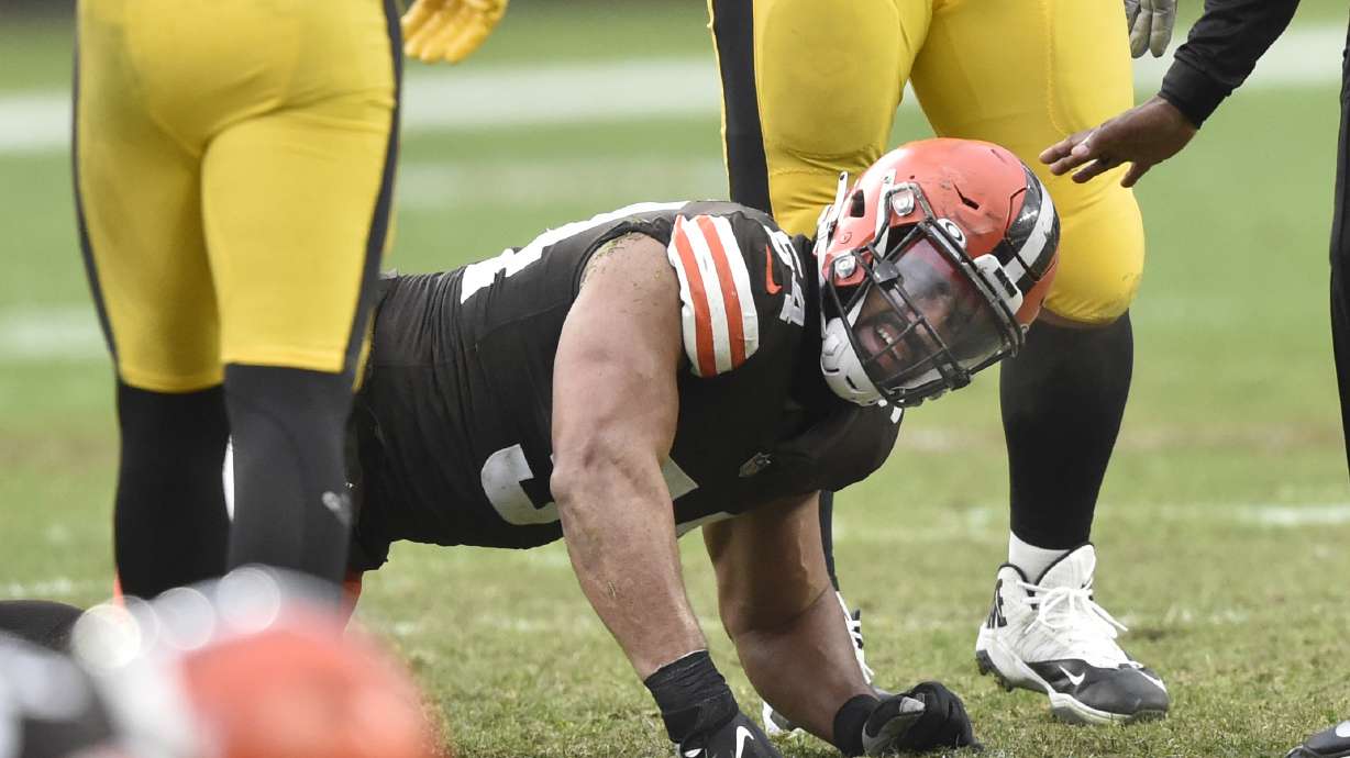 Cleveland Browns defensive end Olivier Vernon reacts after an injury in the fourth quarter of an NFL football game against the Pittsburgh Steelers, Sunday, Jan. 3, 2021, in Cleveland. Hamstring pulls, ligament tears and ankle sprains can be as formidable an opponent for NFL teams as a high-scoring offense or stingy defense.