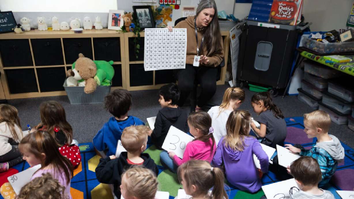 Students listen to kindergarten teacher Stephanie Cobabe at East Sandy Elementary School in Sandy on Feb. 27. The Utah State Board of Education said a website claiming to let families “pre-apply” for those newly passed school vouchers is confusing people into thinking they’re getting pre-qualified.