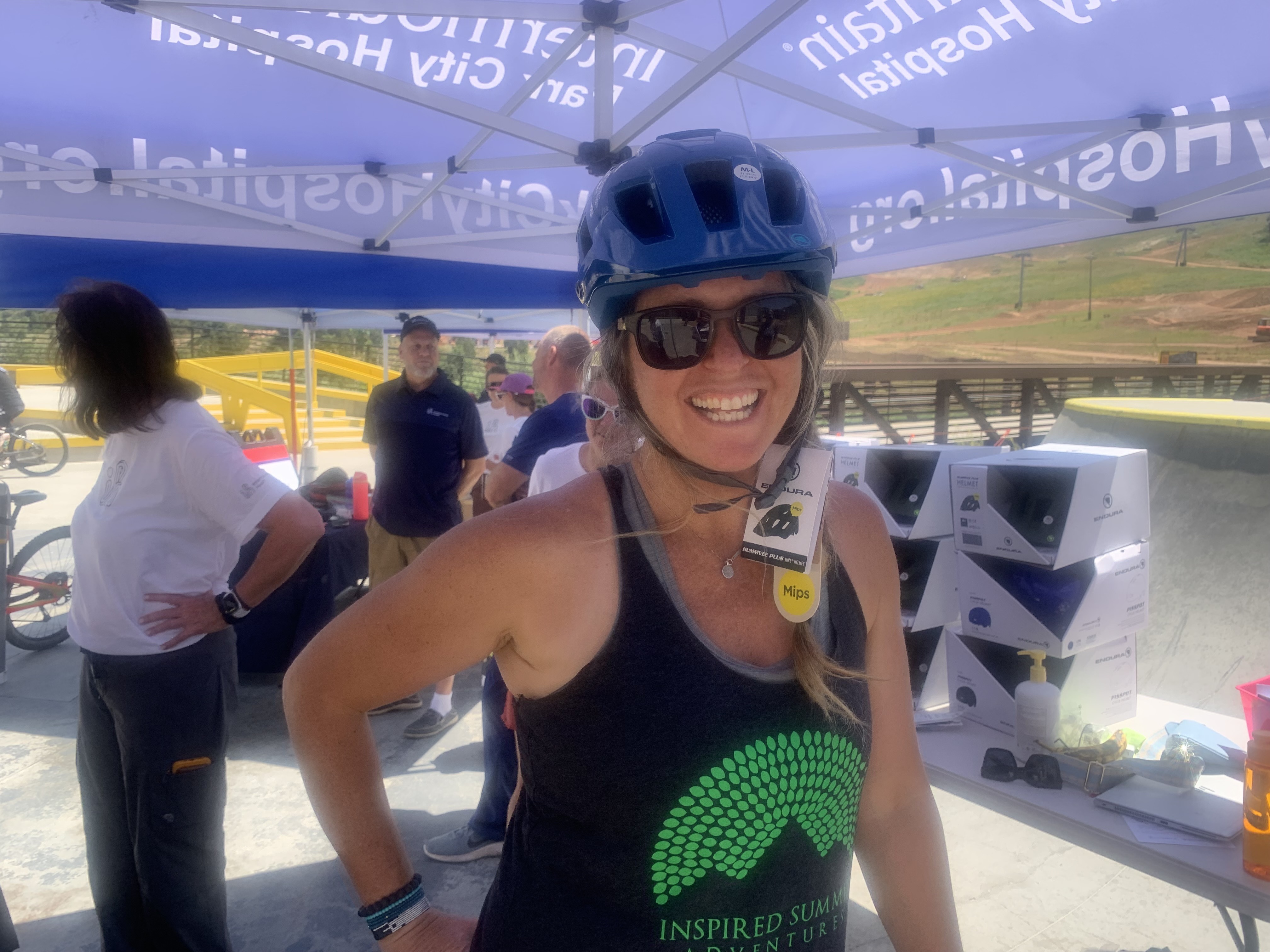 Shaun Deutschlander, a mountain biker, tries on a helmet at an Intermountain Health safety event at Woodward Park City on Friday.