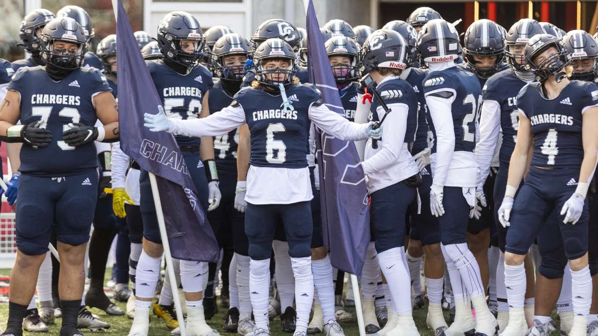 The Corner Canyon Chargers walk onto the field before playing the Skyridge Falcons in the 6A state football championship at Rice-Eccles Stadium at the University of Utah in Salt Lake City on Friday, Nov. 18, 2022. The Falcons won 17-7.