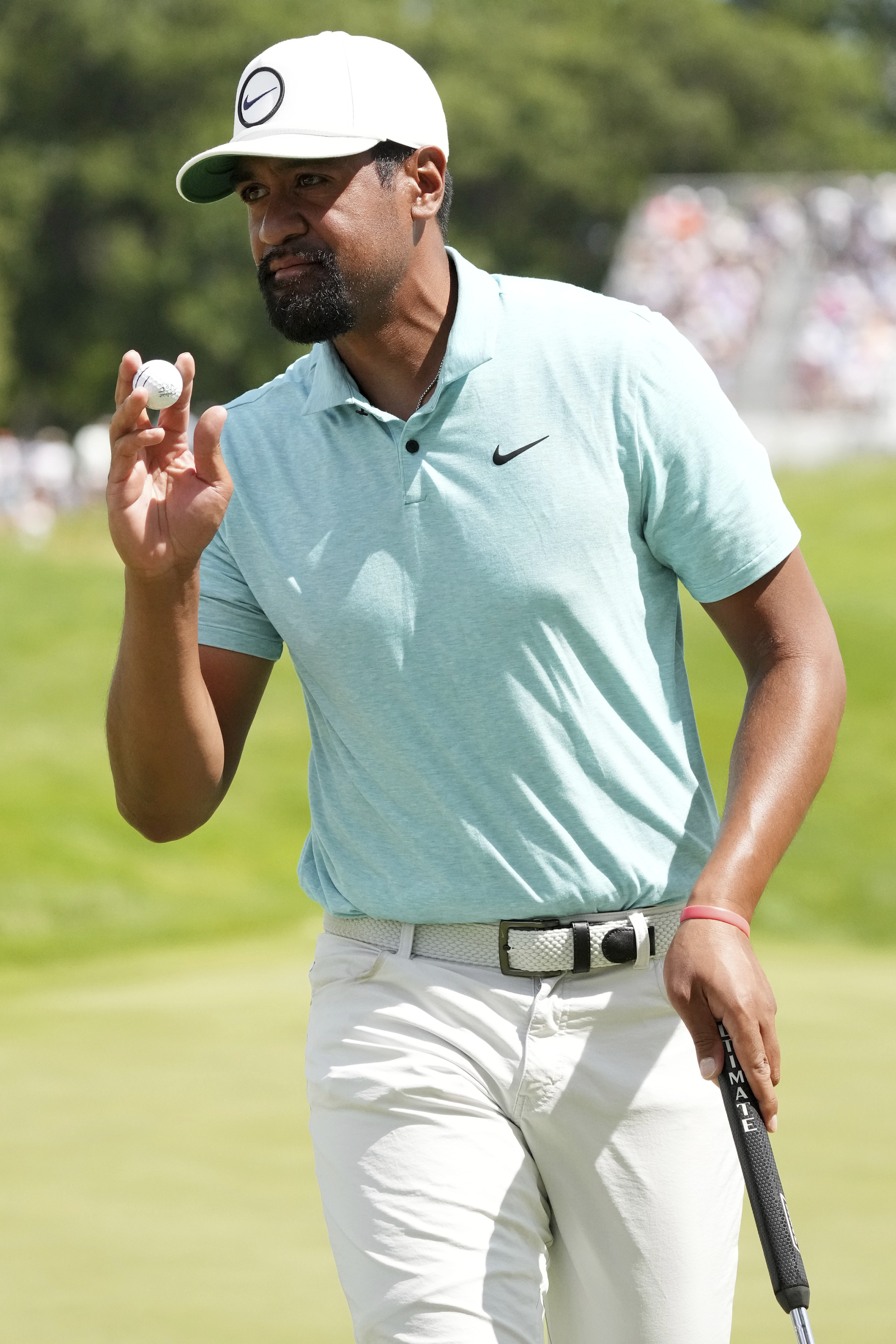 Tony Finau raises his ball after sinking a putt on the 12th green during the third round of the 3M Open golf tournament, Saturday, July 29, 2023 at TPC Twin Cities in Blaine, Minn.