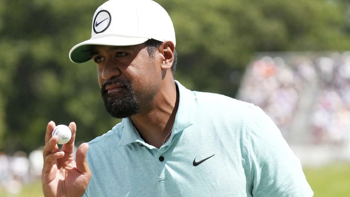 Tony Finau raises his ball after sinking a putt on the 12th green during the third round of the 3M Open golf tournament, Saturday, July 29, 2023 at TPC Twin Cities in Blaine, Minn.