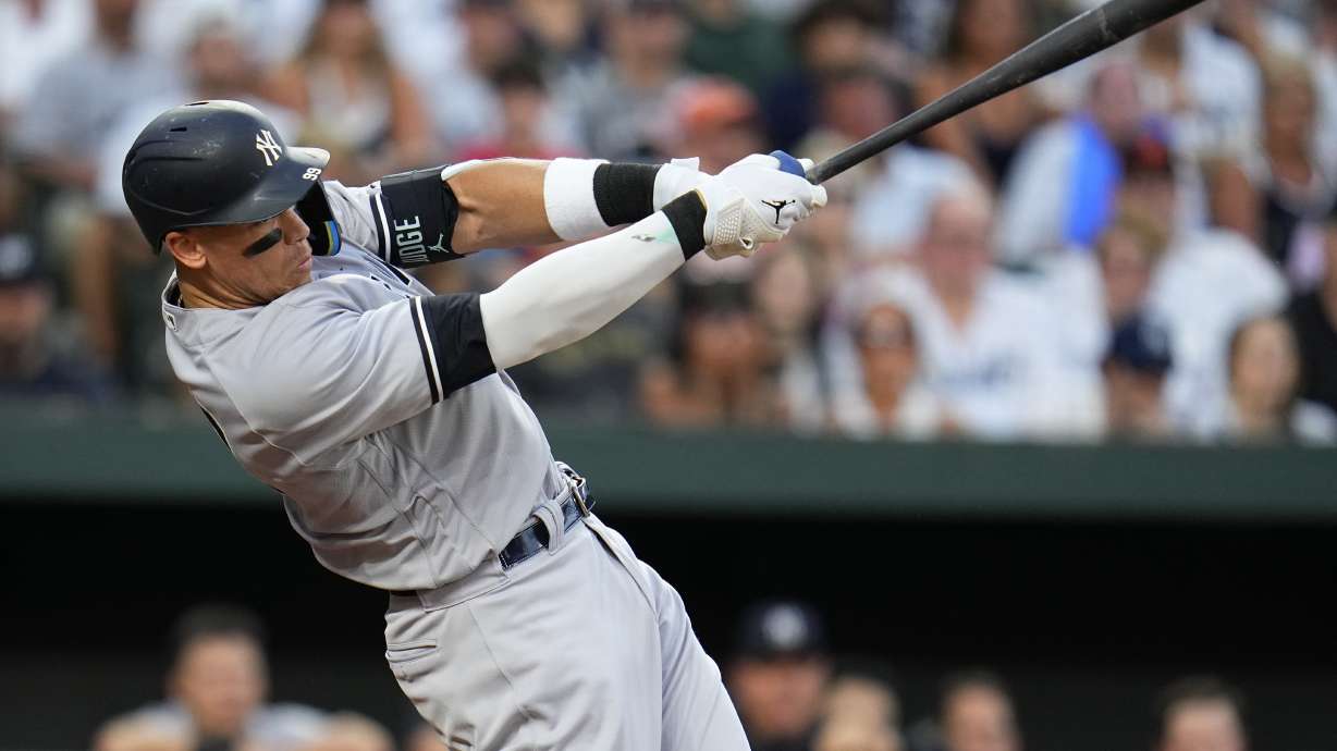New York Yankees' Aaron Judge follows through on a swing as he hits a two-run home run off Baltimore Orioles starting pitcher Tyler Wells during the third inning of a baseball game, Saturday, July 29, 2023, in Baltimore. Yankees' Kyle Higashioka also scored on the home run.