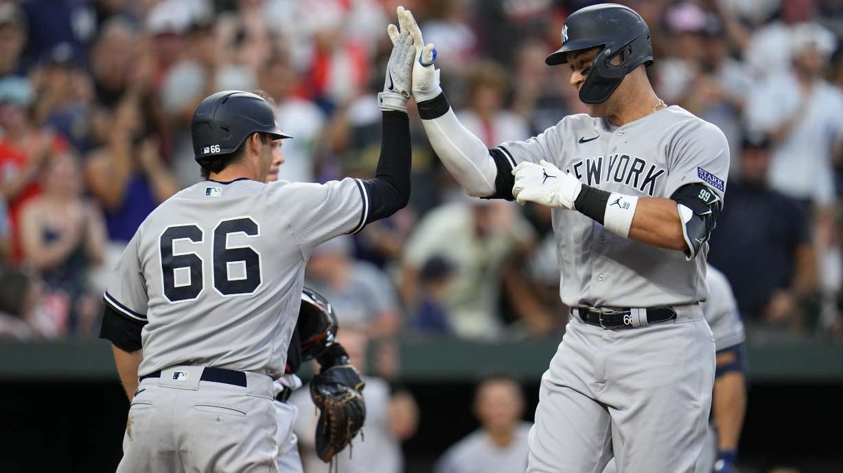 New York Yankees' Aaron Judge, right, is greeted near home plate by Kyle Higashioka (66) after scoring them on a two-run home run off Baltimore Orioles starting pitcher Tyler Wells during the third inning of a baseball game, Saturday, July 29, 2023, in Baltimore.