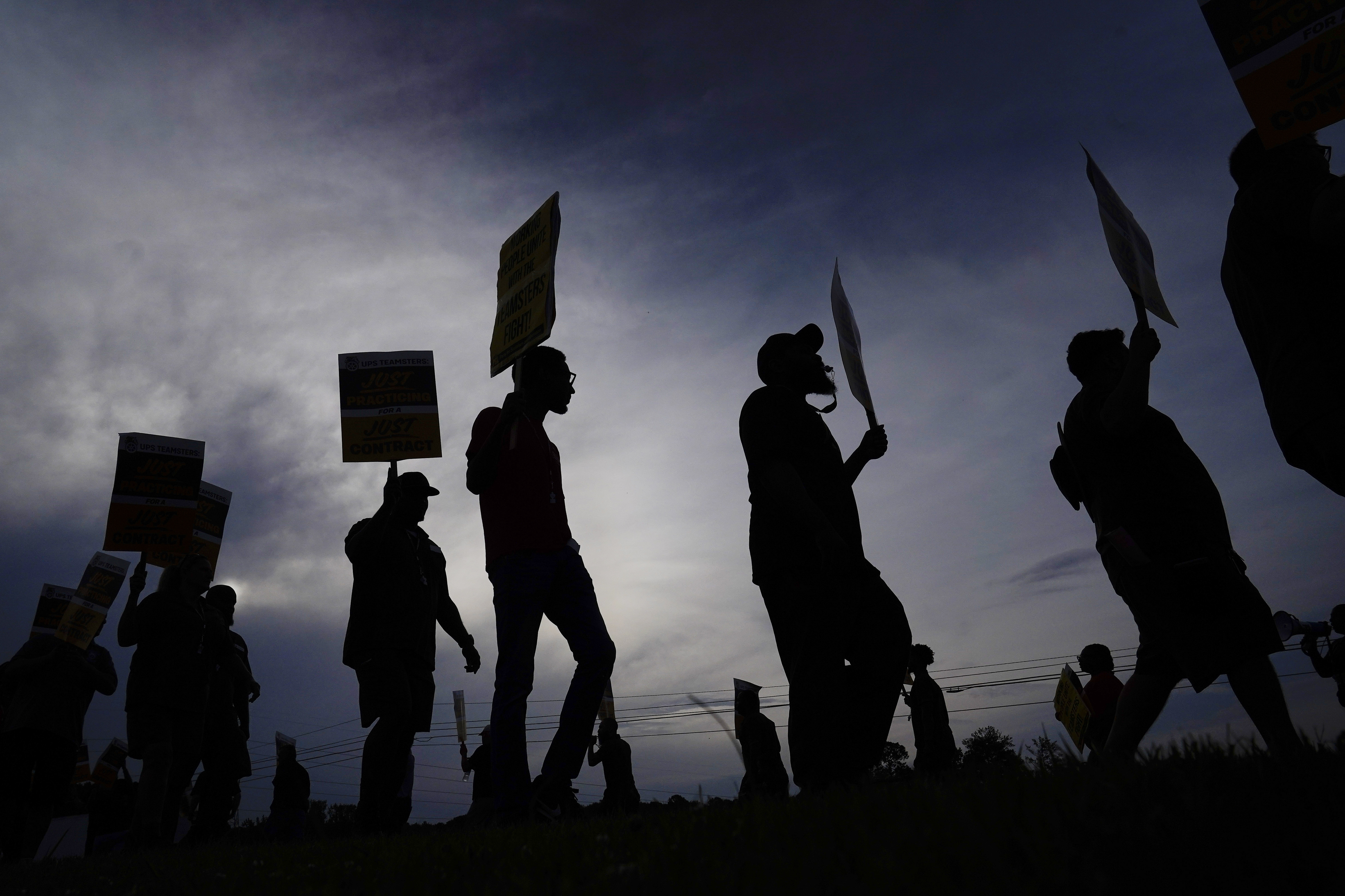 UPS teamsters and workers hold a rally, Friday, July 21, in Atlanta, as a national strike deadline nears. UPS has reached a contract agreement with its 340,000-person strong union Tuesday, averting a strike that had the potential to disrupt logistics nationwide for businesses and households alike.