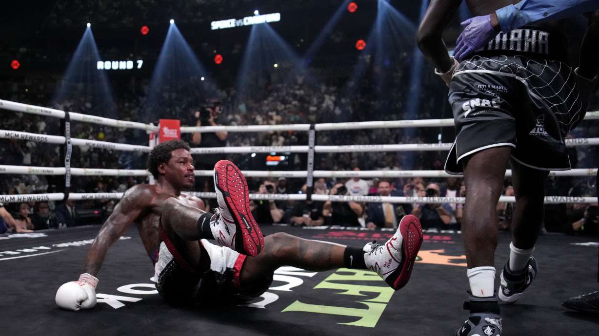 Errol Spence Jr., right, is knocked down by Terence Crawford, right, during their championship boxing match, Saturday, July 29, 2023, in Las Vegas.
