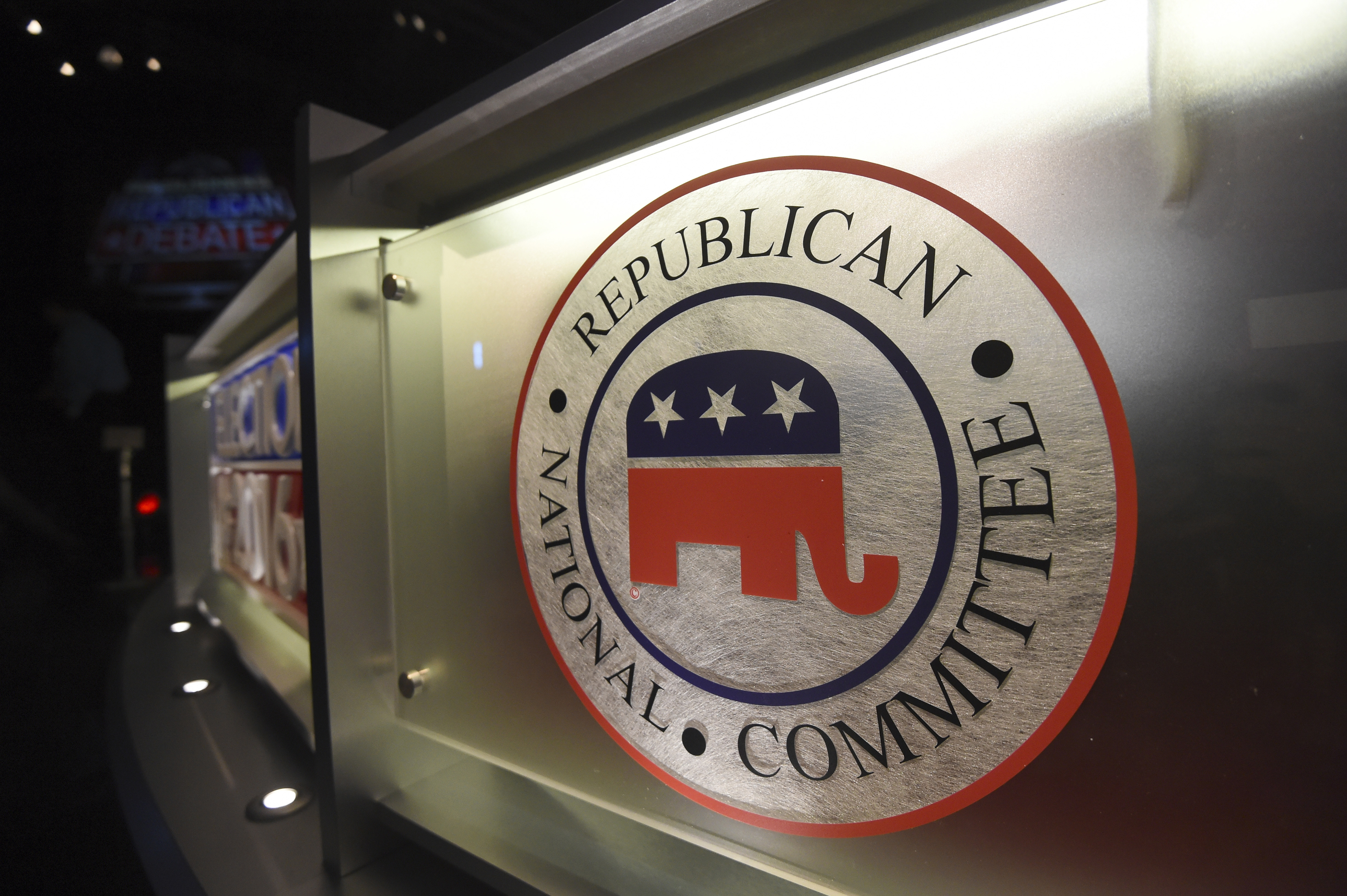 The Republican National Committee logo is shown on the stage as crew members work at the North Charleston Coliseum, Jan. 13, 2016, in North Charleston, S.C. With less than a month to go until the first 2024 Republican presidential debate, seven candidates say they have met the qualifications for a podium slot. But that also means that about half of the broad GOP field is running short on time to make the stage. 