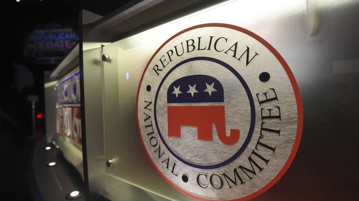 The Republican National Committee logo is shown on the stage as crew members work at the North Charleston Coliseum, Jan. 13, 2016, in North Charleston, S.C. With less than a month to go until the first 2024 Republican presidential debate, seven candidates say they have met the qualifications for a podium slot. But that also means that about half of the broad GOP field is running short on time to make the stage.