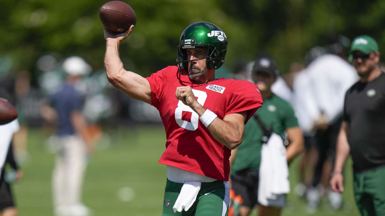New York Jets quarterback Aaron Rodgers throws during a practice session at the NFL football team's training facility in Florham Park, N.J., Sunday, July 30, 2023.