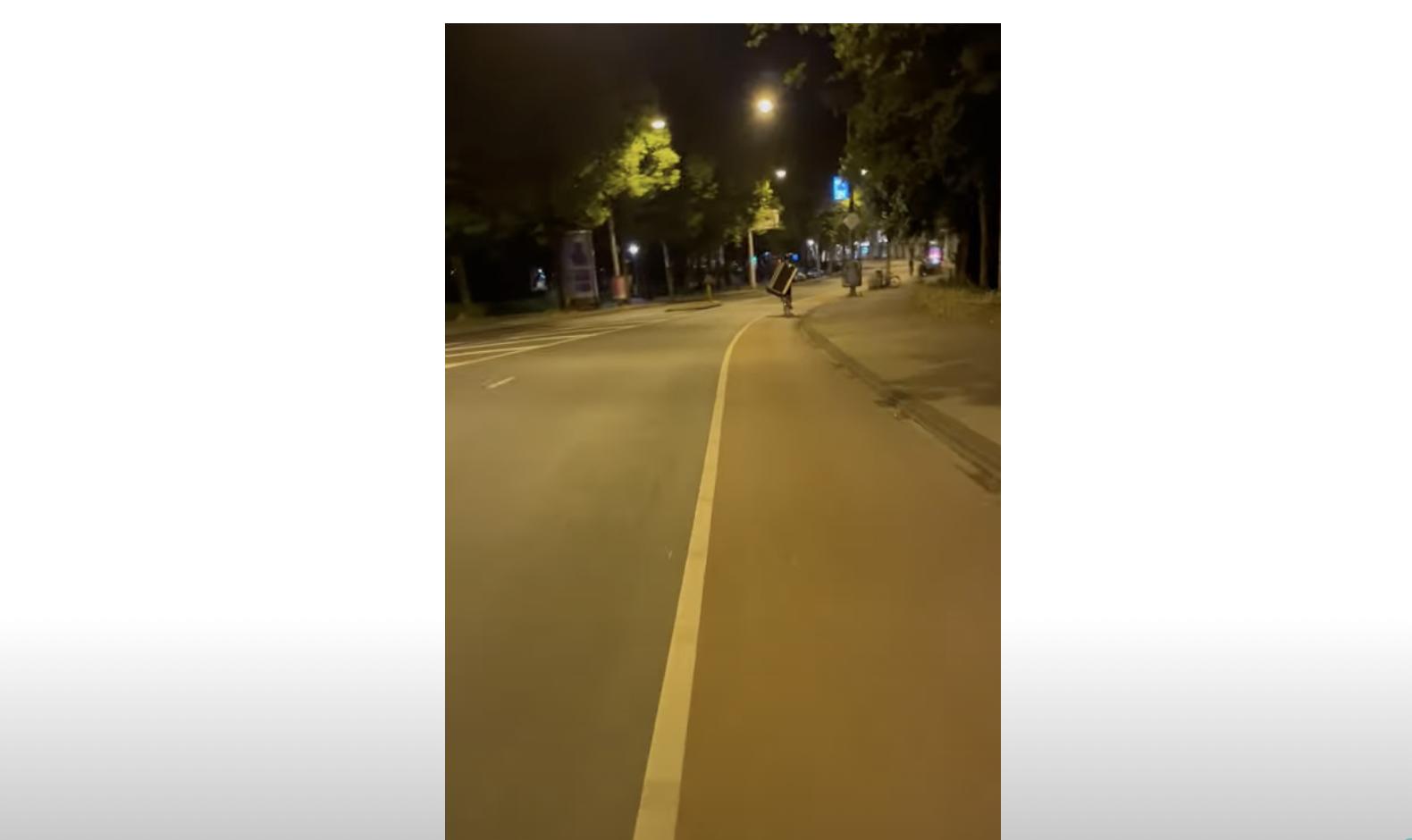 The bike rider almost looks like a turtle thanks to the way it covers his back.