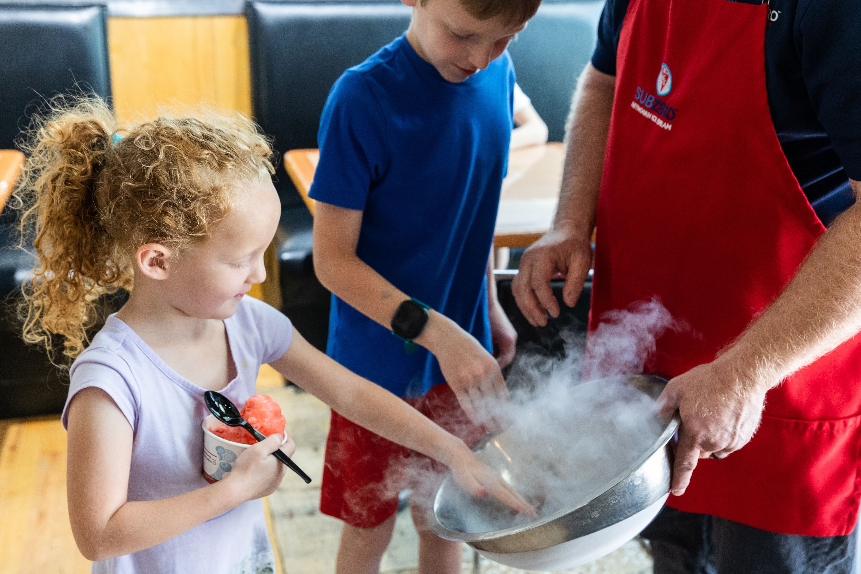 Jerry Hancock, one of the founders of Sub Zero Nitrogen Ice Cream, shows the Larsen family liquid nitrogen at Sub Zero in Provo on July 10.