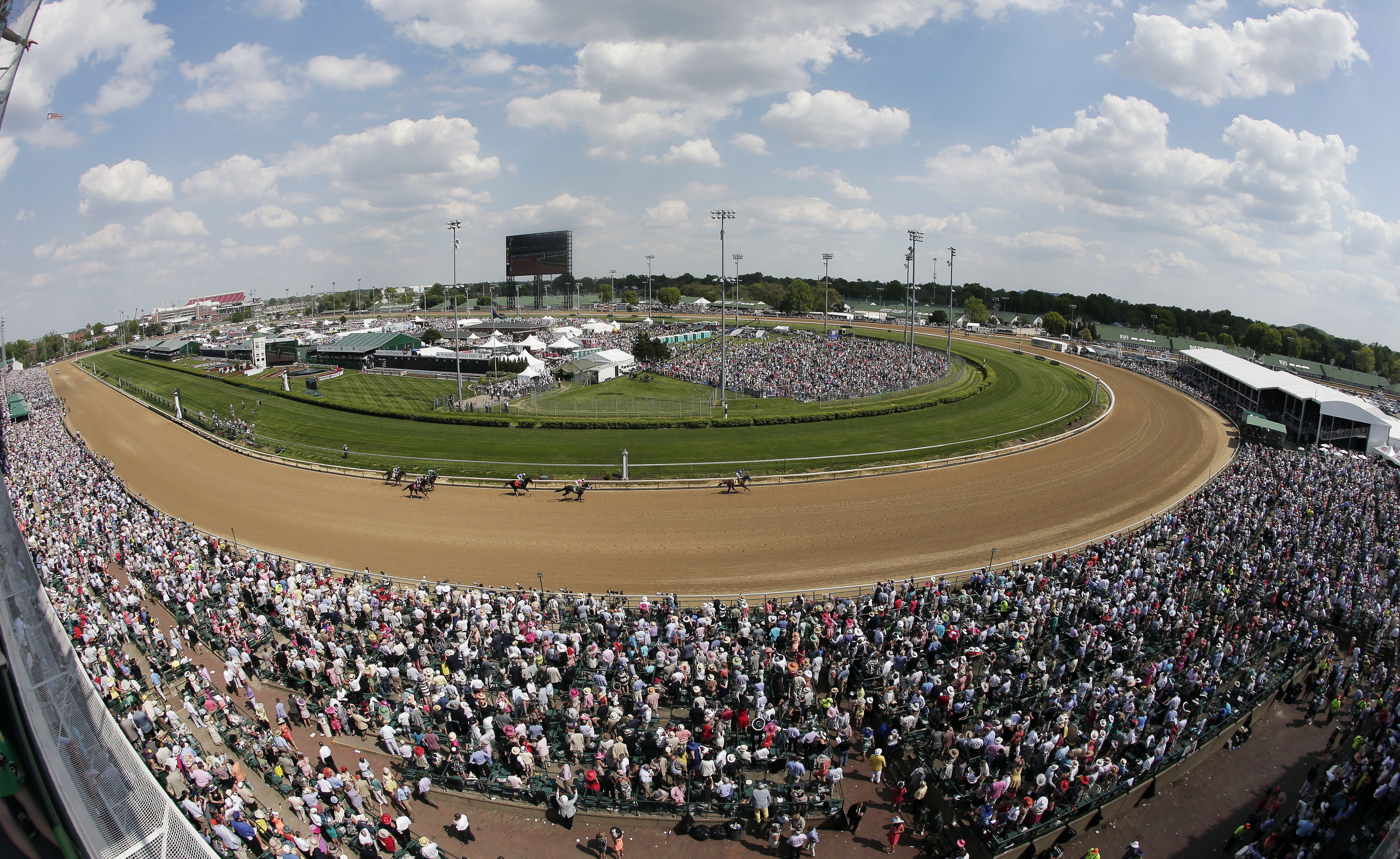 FILE - Fans watch a race before the 141st running of the Kentucky Derby horse race at Churchill Downs in Louisville, Ky., May 2, 2015. Racing will resume at Churchill Downs in September 2023 with no changes being made after a review of surfaces and safety protocols in the wake of 12 horse deaths, including seven in the days leading up to the Kentucky Derby in May. 