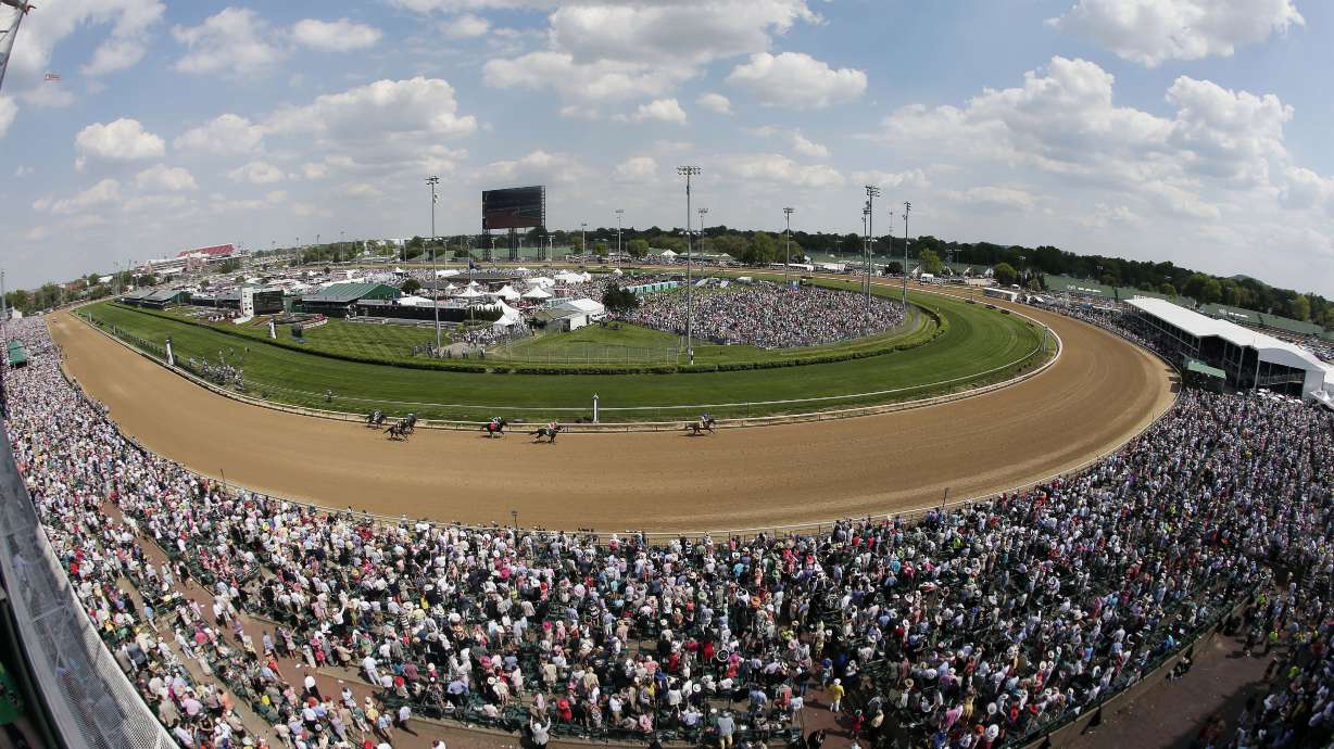 FILE - Fans watch a race before the 141st running of the Kentucky Derby horse race at Churchill Downs in Louisville, Ky., May 2, 2015. Racing will resume at Churchill Downs in September 2023 with no changes being made after a review of surfaces and safety protocols in the wake of 12 horse deaths, including seven in the days leading up to the Kentucky Derby in May.