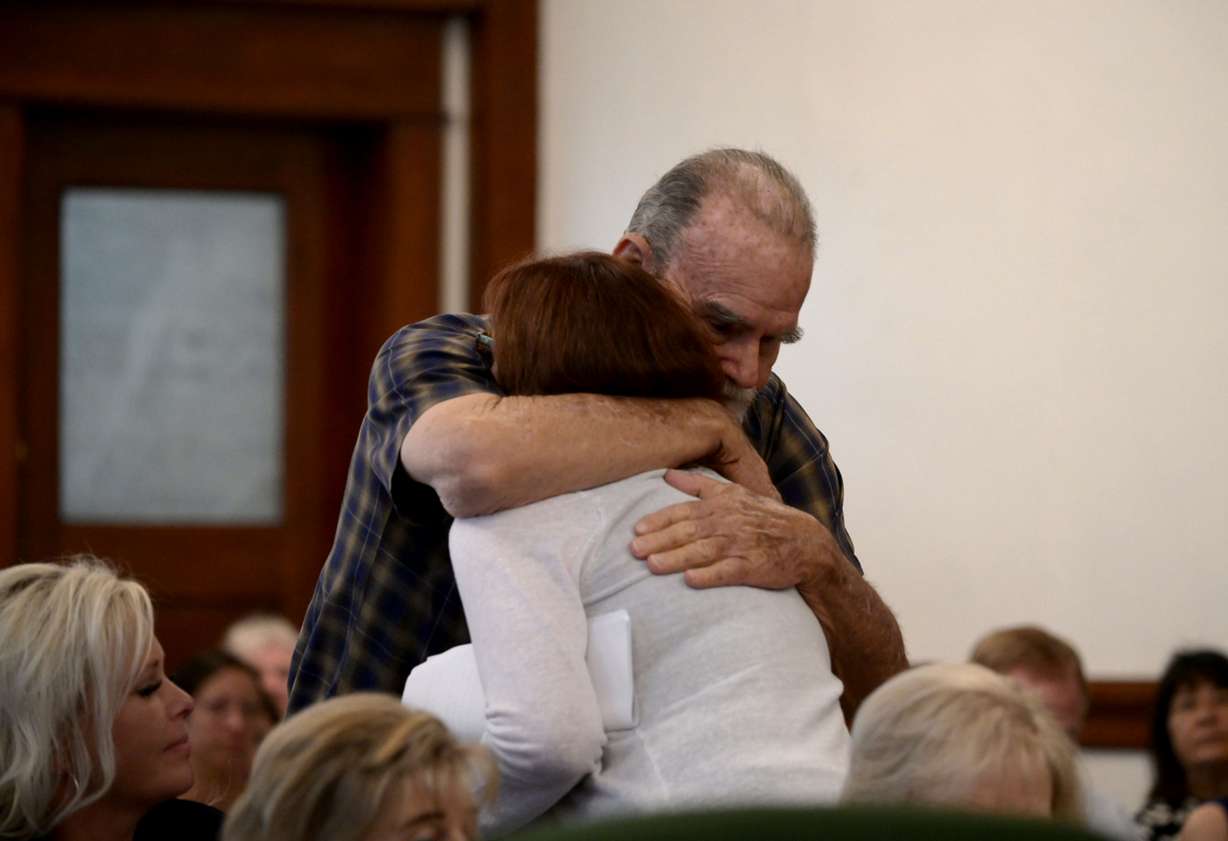 Larry Woodcock, grandfather of Joshua Jaxon "JJ" Vallow, hugs Kay Woodcock, JJ's grandmother, at the sentencing of Lori Vallow Daybell in St. Anthony, Idaho, on Monday. In May, Vallow Daybell was found guilty on six counts that included murder, conspiracy and grand theft related to the deaths of 16-year-old Tylee Ryan and 7-year-old JJ Vallow, and Tammy Daybell, the spouse of Chad Daybell.