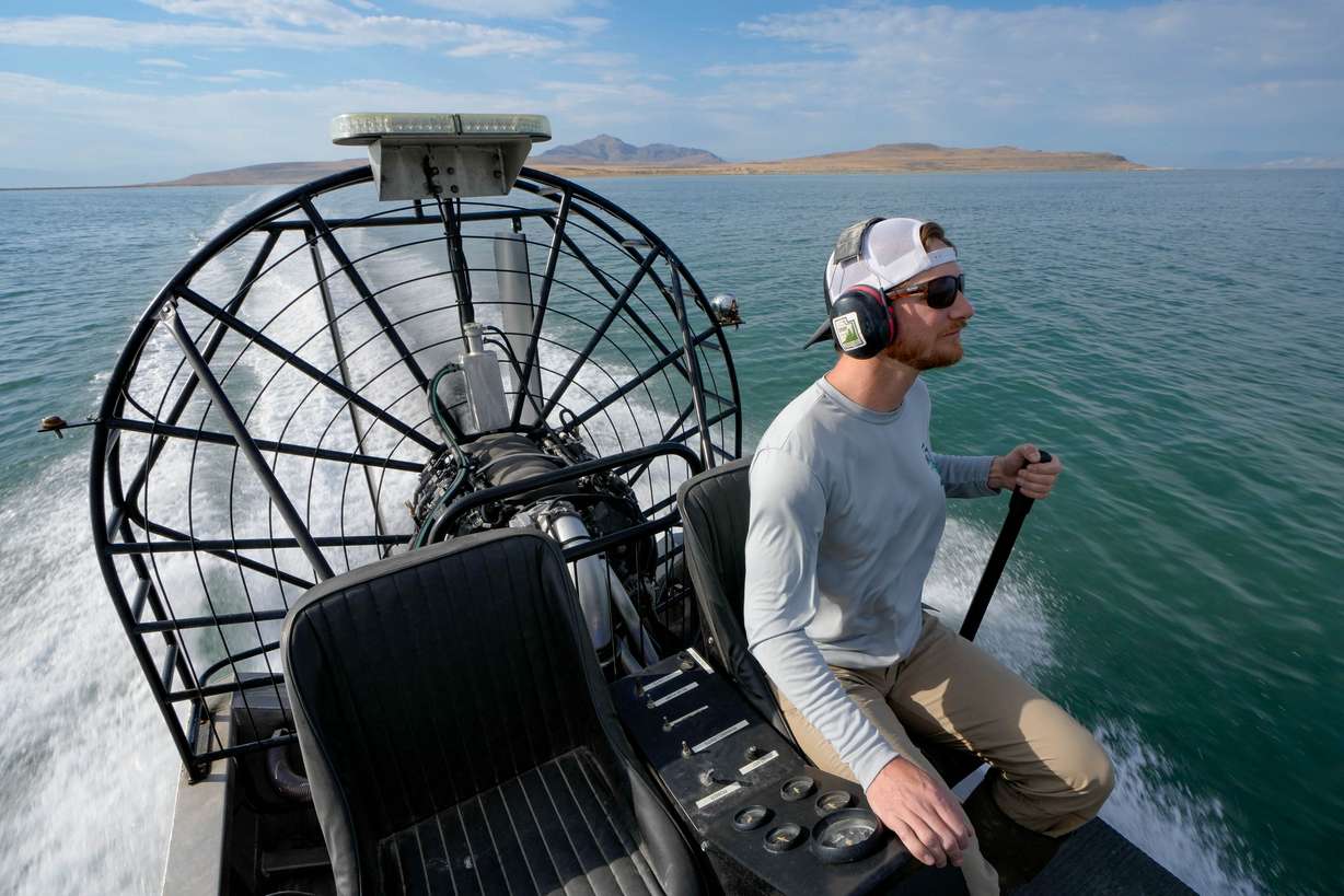 Keith Hambrecht, invasive species coordinator for state lands, pilots an air boat from Antelope Island, in background, to Fremont Island on July 18, for a tour.