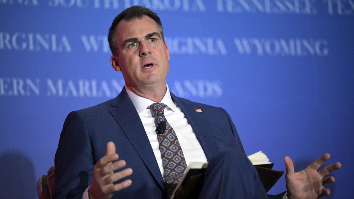 Oklahoma Gov. Kevin Stitt answers a question while taking part in a panel discussion during a Republican Governors Association conference, Nov. 16, 2022, in Orlando, Fla. On Monday a group of parents, faith leaders and a public education nonprofit sued to stop Oklahoma from establishing and funding what would be the nation’s first religious public charter school.