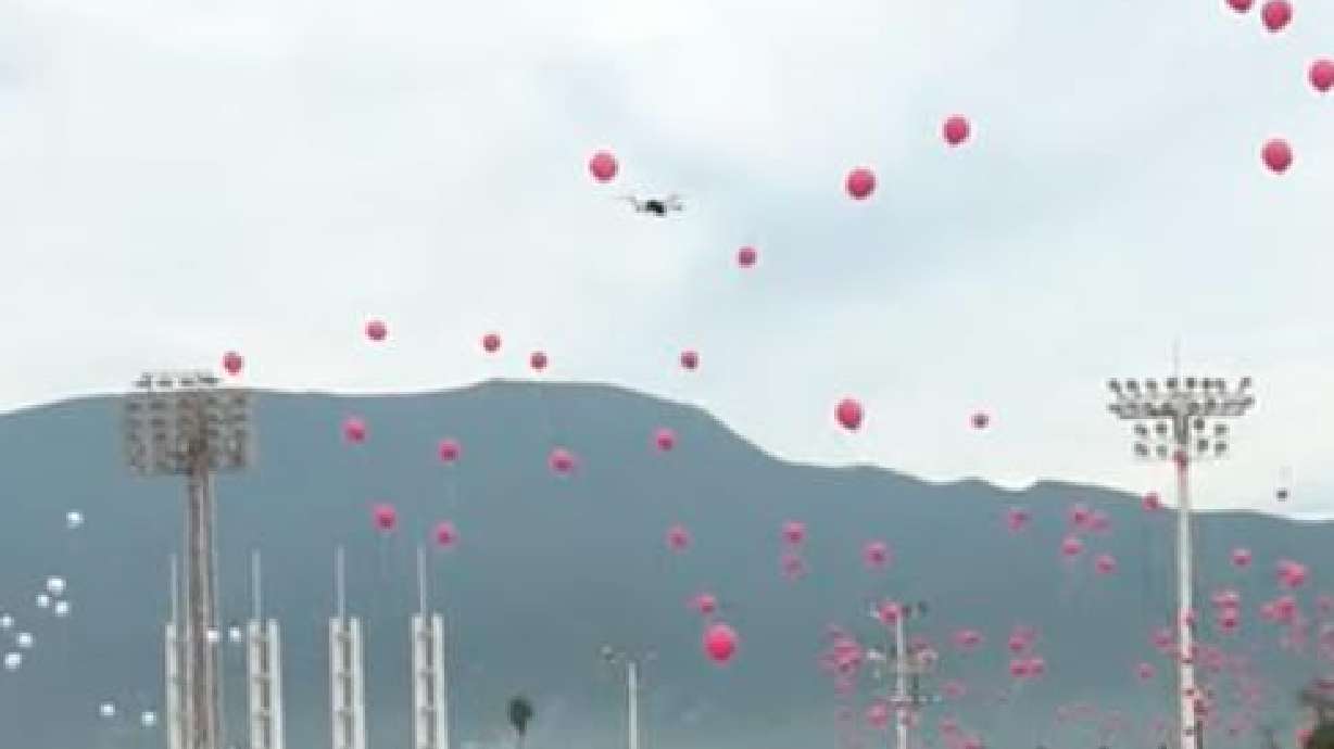 A drone flies amid a balloon launch in Mexico, but the drone doesn't seem to capture much as it spirals to the ground.