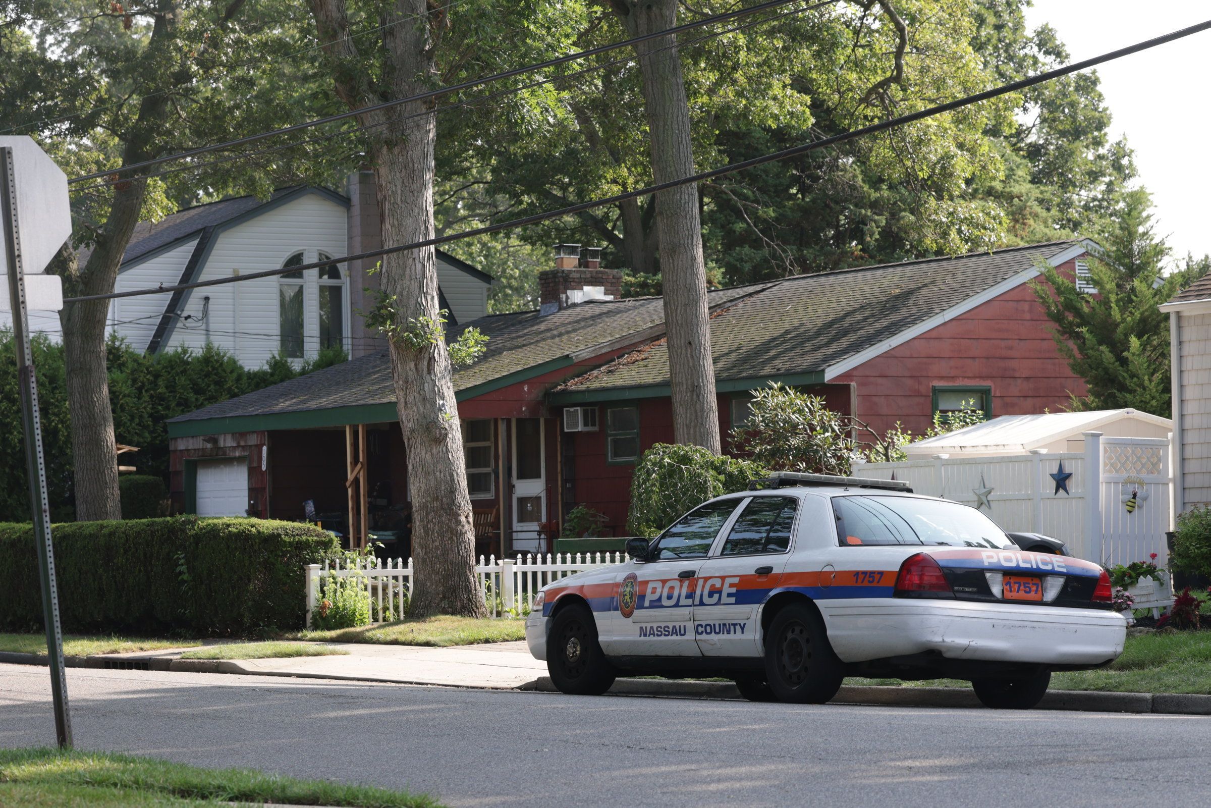 Nassau County police car is parked outside the home of the alleged killer of three sex workers in the Gilgo Beach case, Rex Heuermann, on Wednesday.