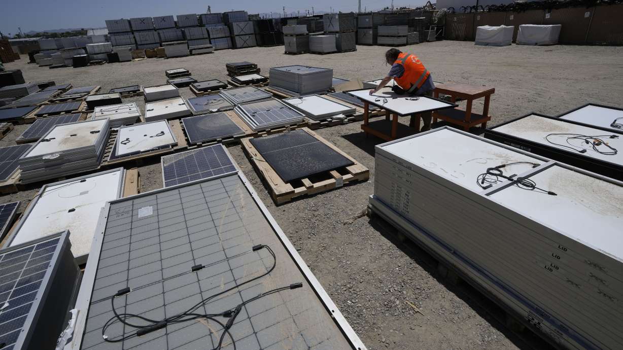 Dwight Clark inspects a used solar panel at We Recycle Solar on June 6, in Yuma, Ariz. North America’s first utility-scale solar panel recycling plant opened to address what founders of the company call a “tsunami” of solar waste.