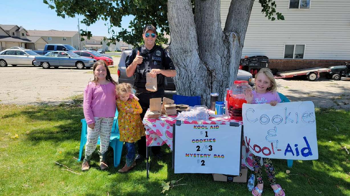 A Tremonton-Garland police officer visits a lemonade stand on July 25 as part of a Box Elder County contest to see which police department could visit the most lemonade stands during the month of July. Tremonton-Garland police won with 54 stand visits.