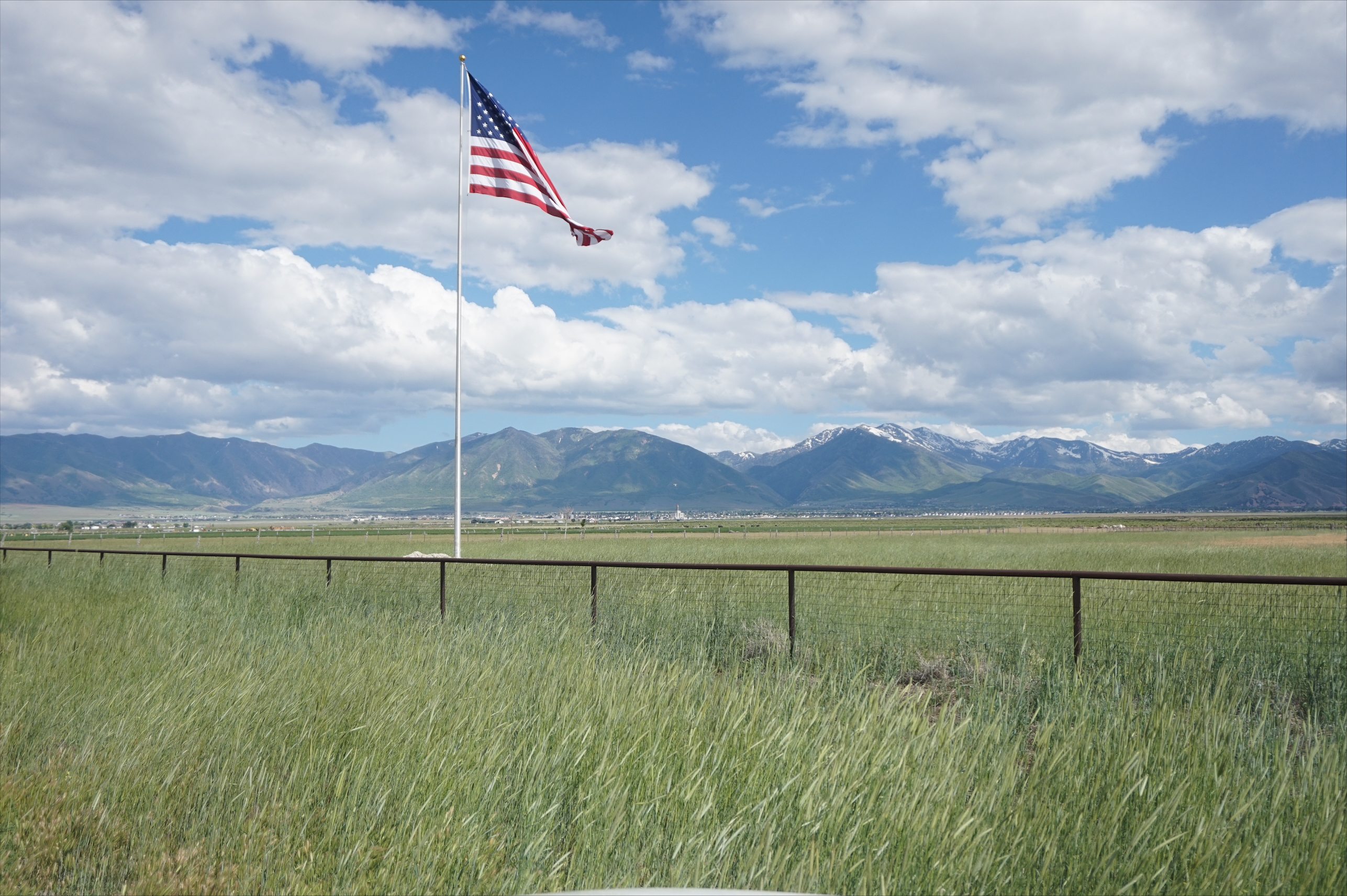 An American flag flies at the top of an 80-foot flagpole erected on private land just outside of the Tooele Valley Airport in Erda on June 4. Salt Lake City, which owns the airport, filed a lawsuit against the land owner and Erda over the pole, saying it's a "hazard" and disrupting some airport operations.