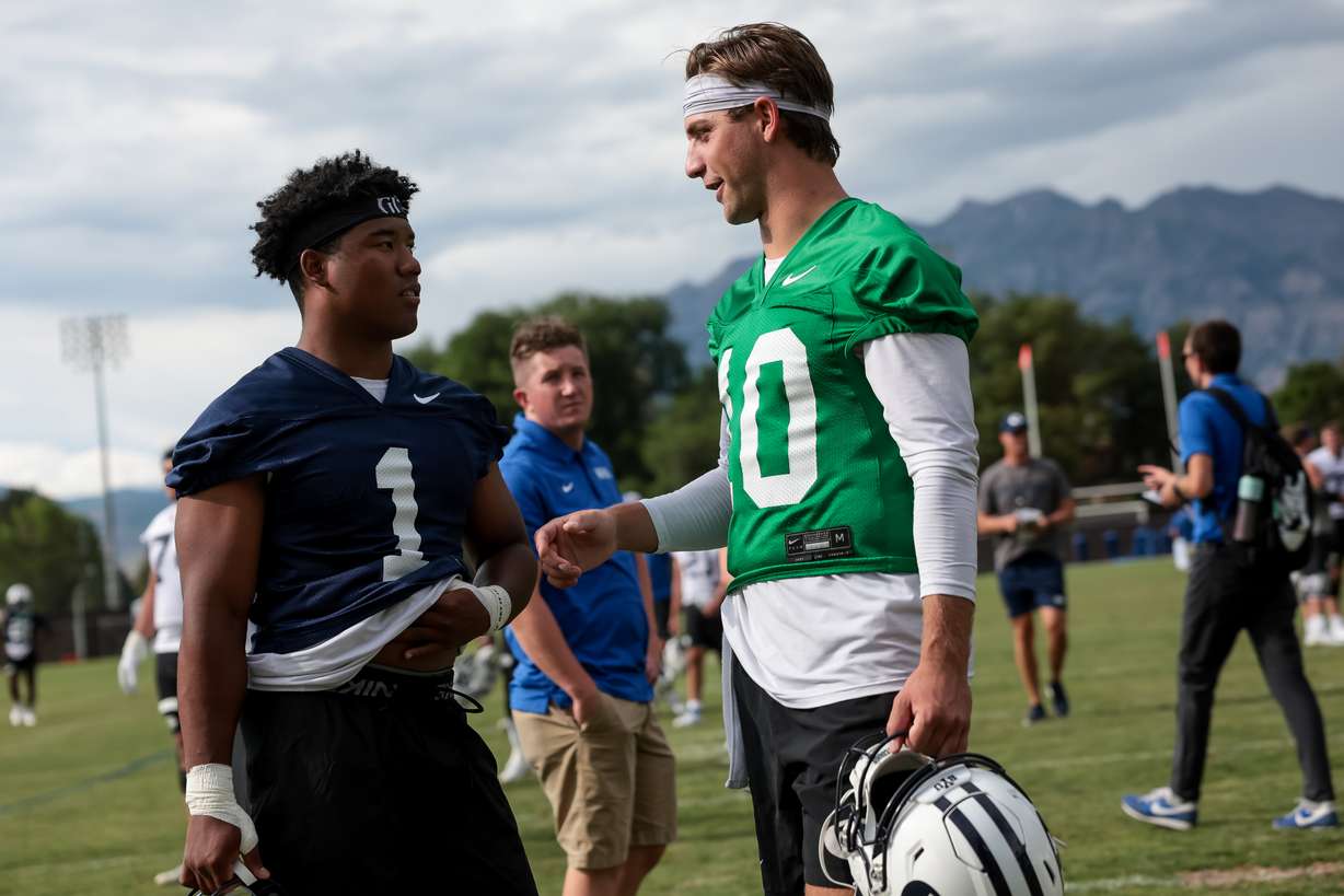 BYU safety Micah Harper and quarterback Kedon Slovis talk after practice at Brigham Young University in Provo on Tuesday, Aug. 1, 2023.