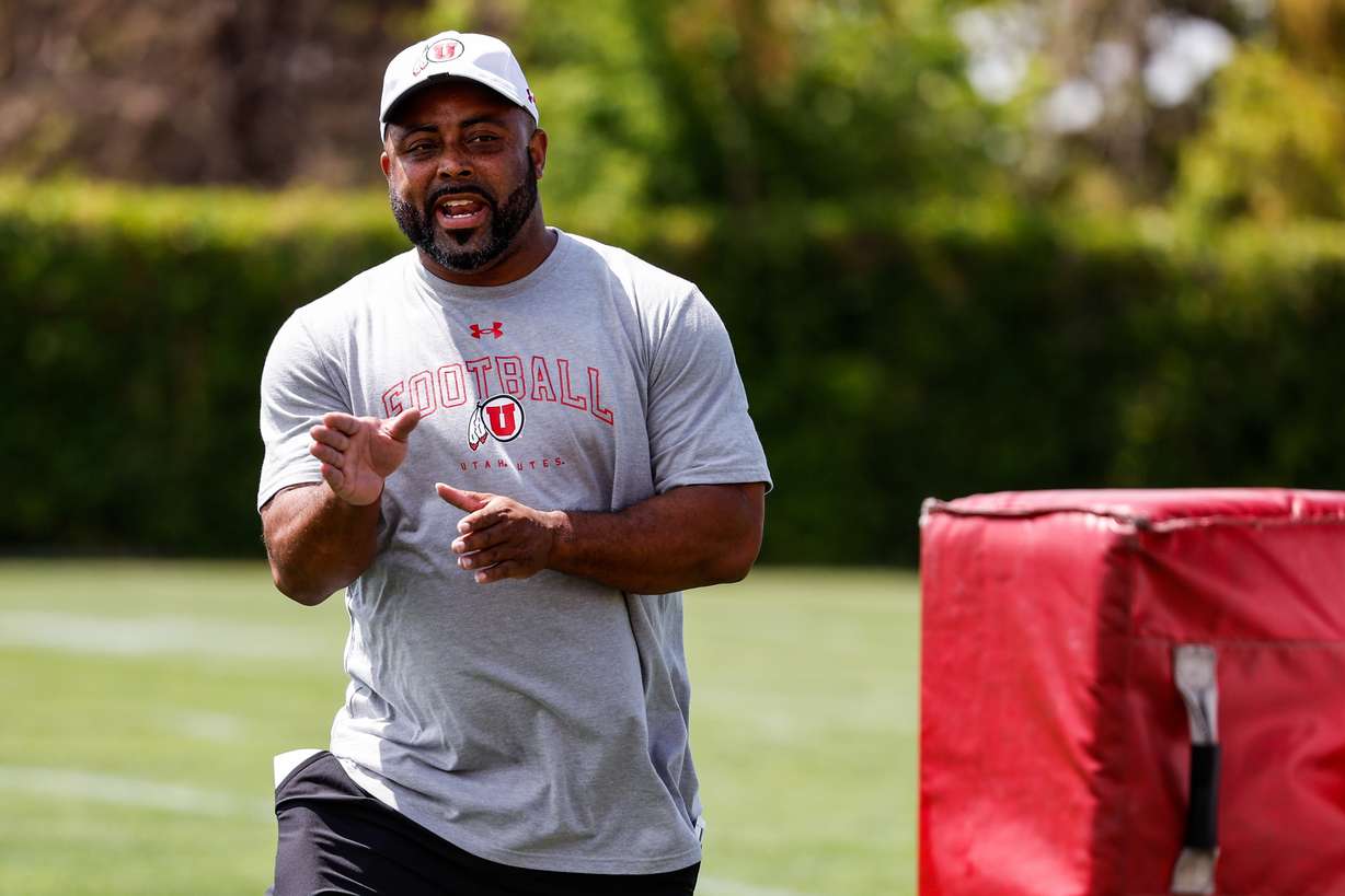 Running back coach Quinton Ganther talks to his players during the first day of fall camp in Salt Lake City on July 31, 2023.
