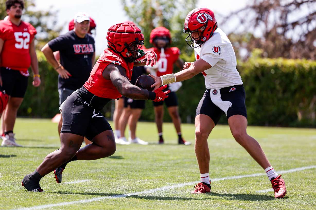 Sophomore running back Jaylon Glover (1) receives a handoff during the first day of fall camp in Salt Lake City on July 31, 2023.